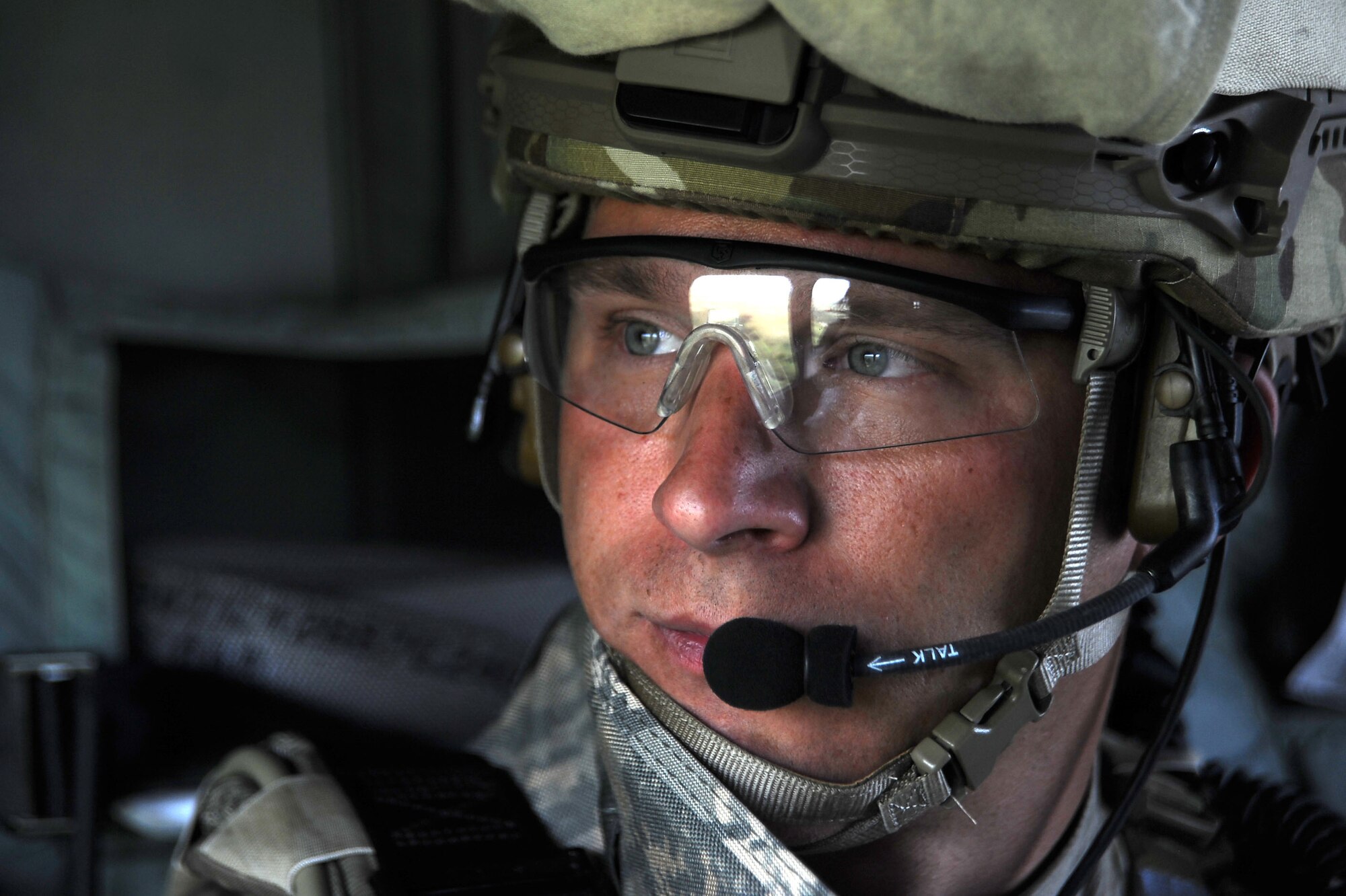 Tech. Sgt. Derrick Fitzhugh, 10th Air Support Operations Squadron, joint terminal attack controller, stares out the window of a UH-60 Blackhawk, June 22, 2016, at Fort Riley, Kan. JTAC Airmen imbed with Army and Marine units on the frontline and are responsible for calling in air strikes during missions.  (U.S. Air Force photo/Airman 1st Class Jenna K. Caldwell) 