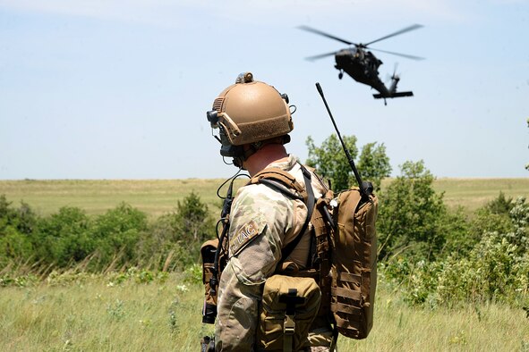 A 10th Air Support Operations Squadron joint terminal attack control Airman watches as a UH-60 Blackhawk approaches to land, June 22, 2016, at Fort Riley, Kan. JTAC Airmen authenticated and recovered 10 downed aircrew during a joint-training exercise with the Army. (U.S. Air Force photo/Airman 1st Class Jenna K. Caldwell)