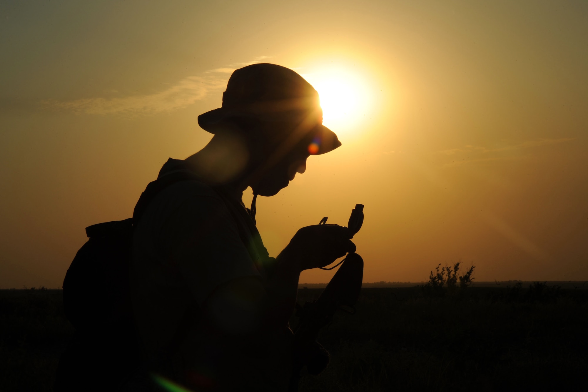 A 10th Air Support Operations Squadron joint terminal attack controller studies a compass during land navigation operations, June 22, 2016, at Fort Riley, Kan. Tenth ASOS JTAC Airmen conducted mission planning and simulated coordination with combat air resources as they performed nighttime convoys and land navigation during their field training exercise. (U.S. Air Force photo/Airman 1st Class Jenna K. Caldwell)