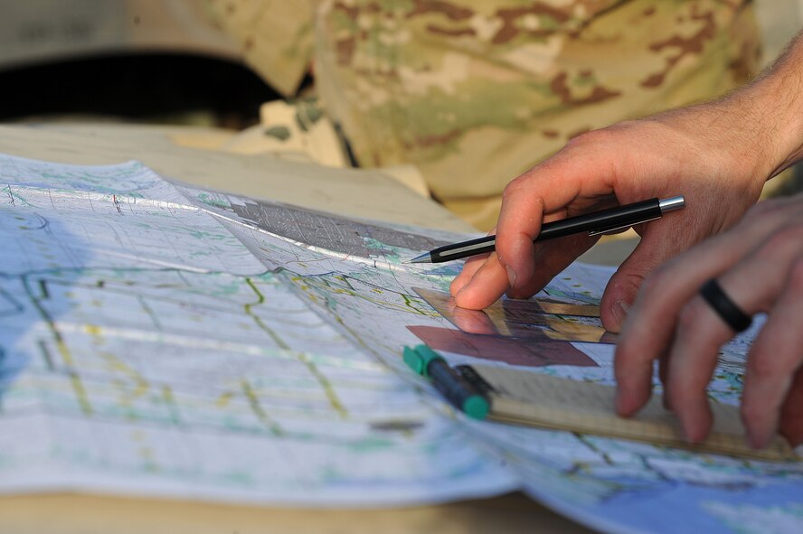 A 10th Air Support Operations Squadron joint terminal attack control Airmen reads a map before nighttime convoy operations, June 22, 2016, at Fort Riley, Kan. Tenth ASOS JTAC Airmen conducted mission planning and simulated coordination with combat air resources as they performed nighttime convoys and land navigation during their field training exercise. (U.S. Air Force photo/Airman 1st Class Jenna K. Caldwell)