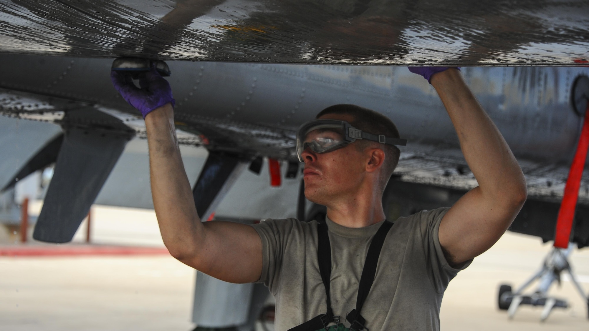 U.S. Air Force Airman 1st Class Ryan Meilleur, 354th Aircraft Maintenance Unit crew chief, washes an A-10C Thunderbolt II on the flightline of Davis-Monthan Air Force Base, Ariz., June 29, 2016. The A-10 Thunderbolt IIs are the first Air Force aircraft specially designed to deliver close air support to ground forces. (U.S. Air Force photo by Airman 1st Class Mya M. Crosby/Released)