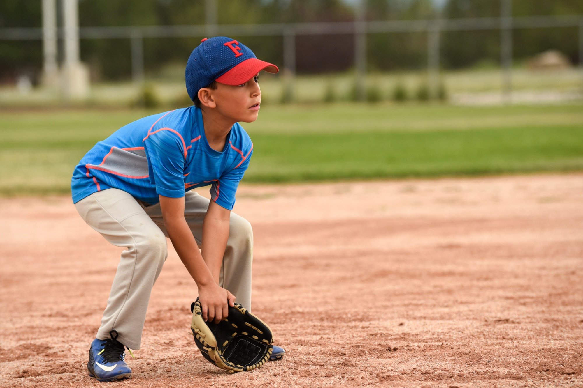 PETERSON AIR FORCE BASE, Colo. – Christopher Pfeifer, 8, gets ready to field a ground ball during a Start Smart baseball practice here June 27, 2016. The youth sports program at the R.P. Lee Youth Center provides Peterson youth with a fun and safe way to practice new sporting skills. (U.S. Air Force photo by Senior Airman Rose Gudex)
