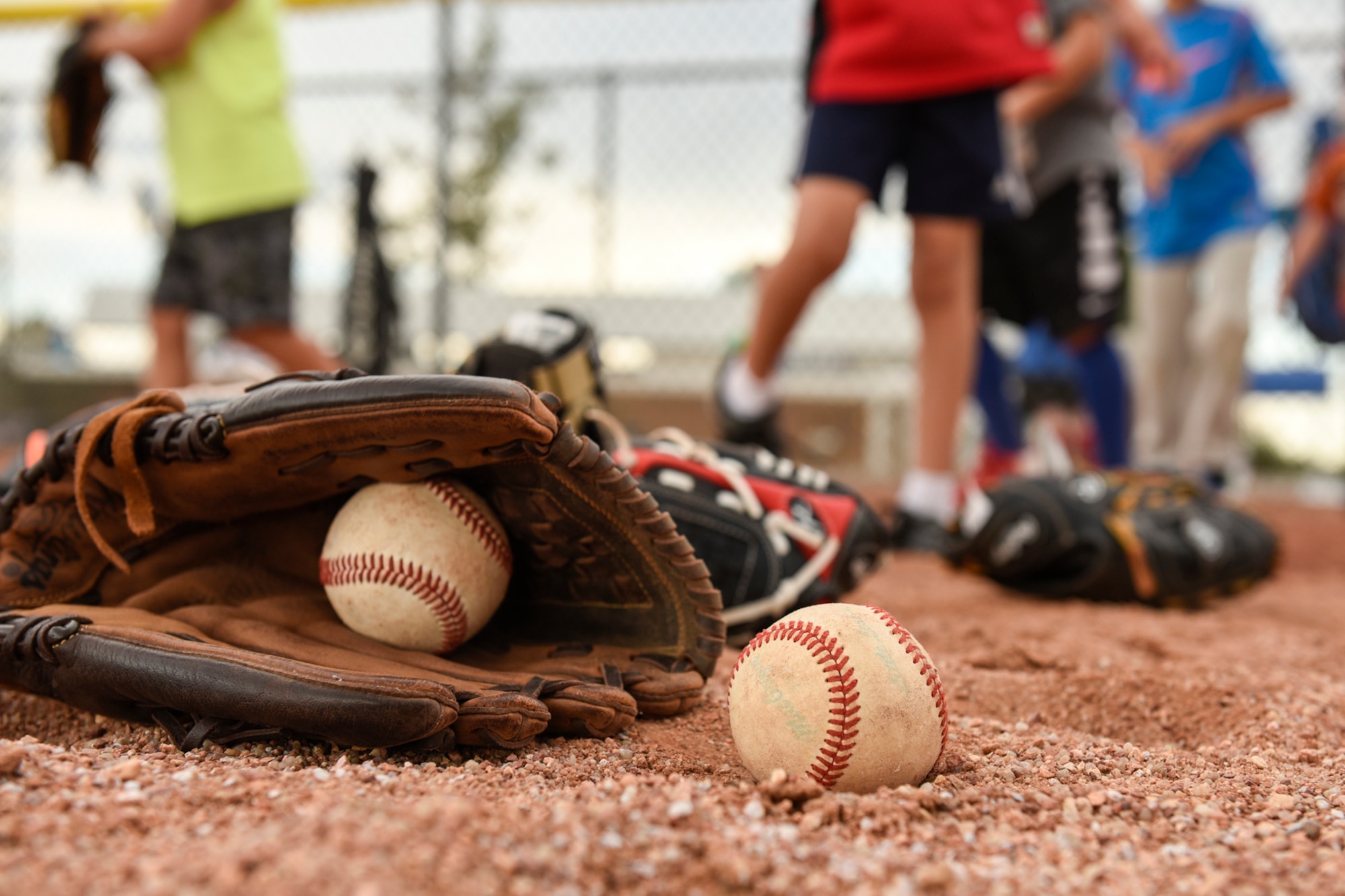 PETERSON AIR FORCE BASE, Colo. – Peterson youth grab their baseball mitts and get ready for fielding practice at the baseball fields here June 27, 2016. They were part of the R.P. Lee Youth Center youth sports program and learning different baseball skills at different stations on the field. (U.S. Air Force photo by Senior Airman Rose Gudex)