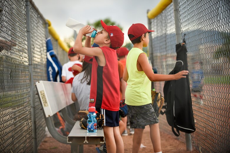 PETERSON AIR FORCE BASE, Colo. – Peterson youth gulp water between drills during a Start Smart baseball practice here June 27, 2016. Start Smart is an eight-week program offered through National Alliance for Youth Sports and was created to develop sports techniques in an environment that’s both fun and safe. (U.S. Air Force photo by Senior Airman Rose Gudex)