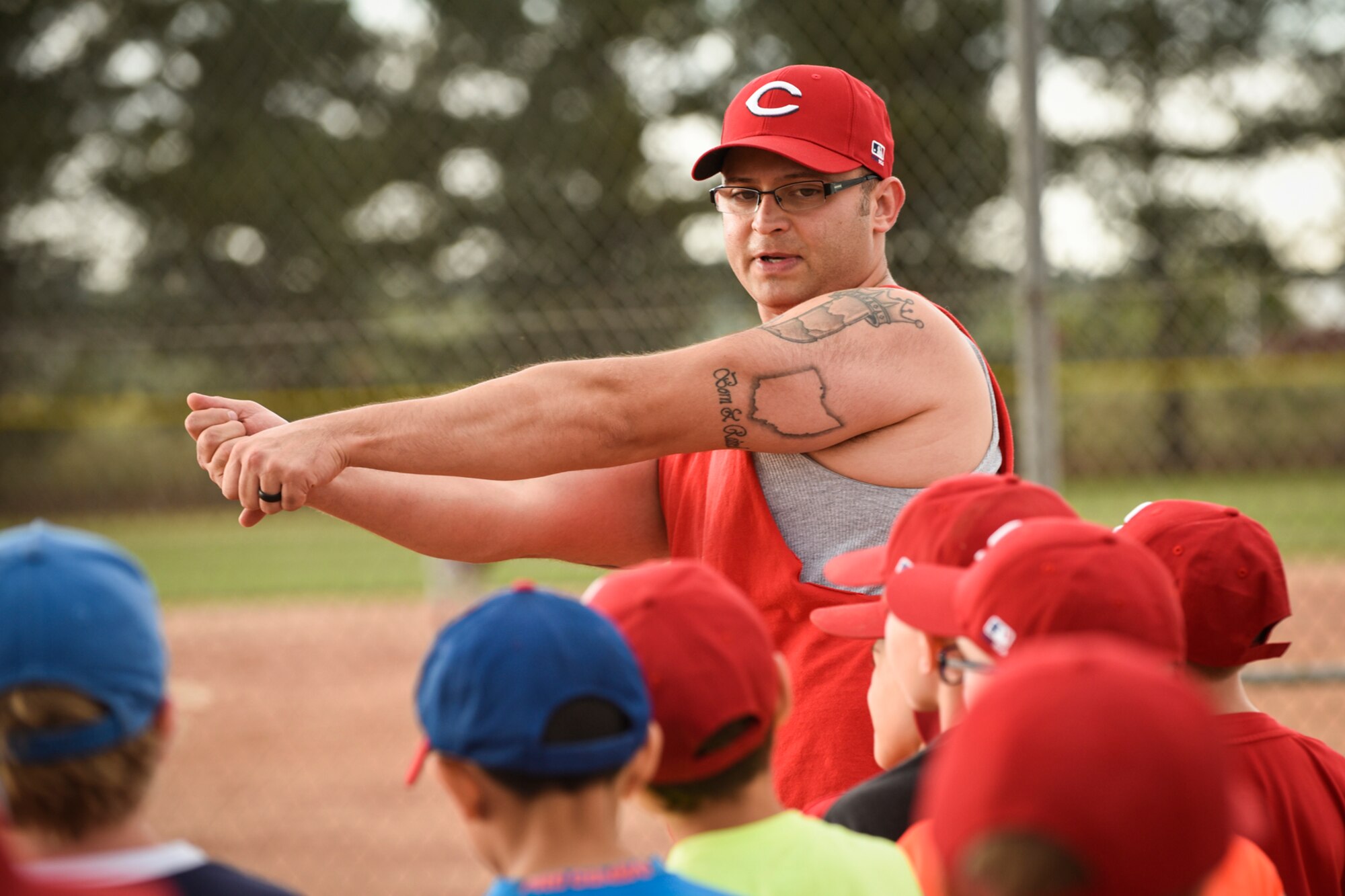 PETERSON AIR FORCE BASE, Colo. – Tech. Sgt. Albert Stoner, 21st Operations Support Squadron and coach, demonstrates how to hit a baseball during a Start Smart baseball practice herre June 27, 2016. Kids worked on different skillsets including fielding a one-hop ground ball and advancing bases. (U.S. Air Force photo by Senior Airman Rose Gudex) 