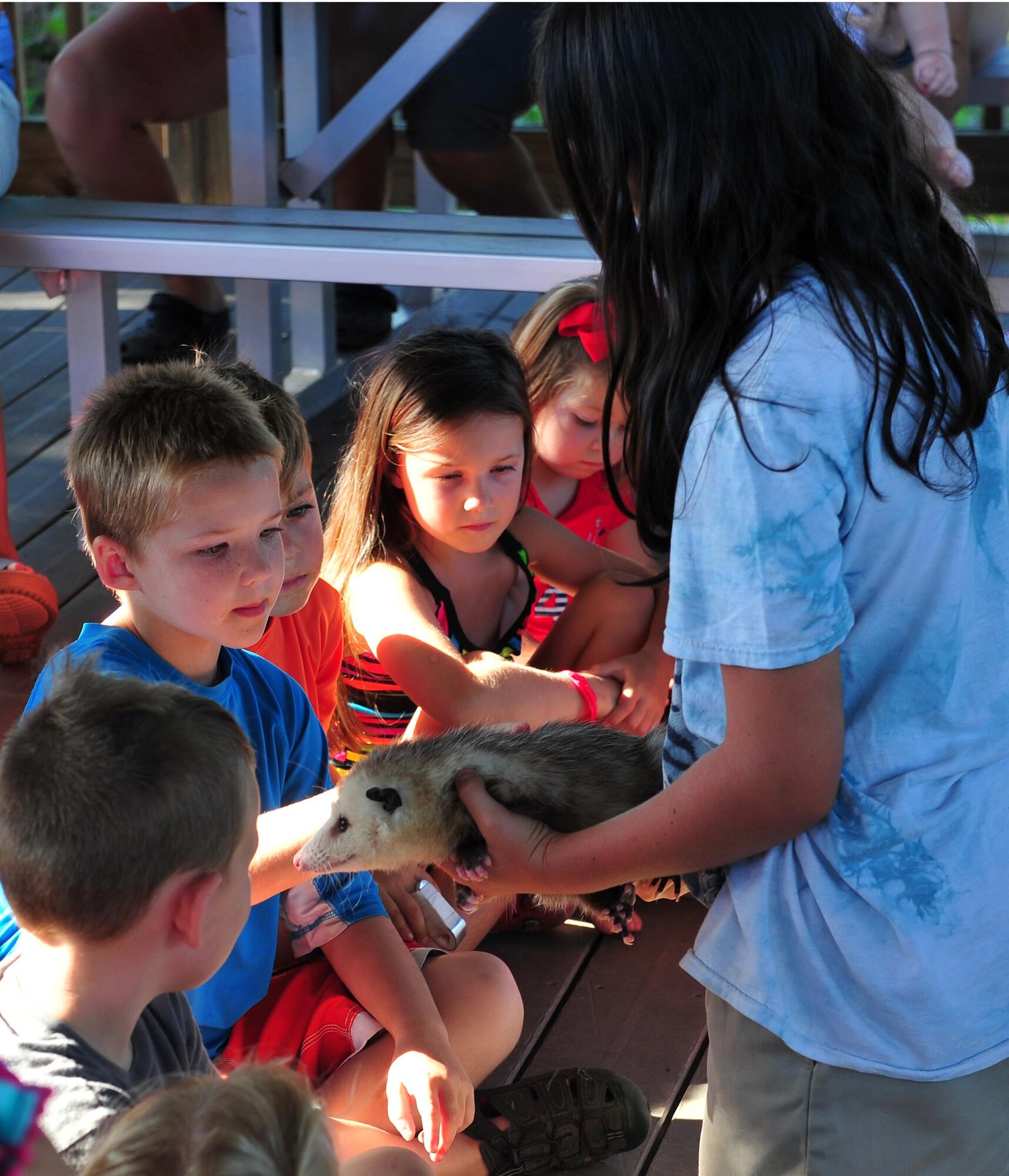 Hurlburt Field children pass around a possum during a animal encounter event at the Soundside Marina on Hurlburt Field, Fla., June 23, 2016. The animal introdctions were part of a Key Spouse and Deployed Family Barbeque, one of several events hosted by the Airmen and Family Readiness Center to help familes of deployed Airmen develope and stregthen their support network. (U.S. Air Force photo by Staff Sgt. Kentavist P. Brackin)