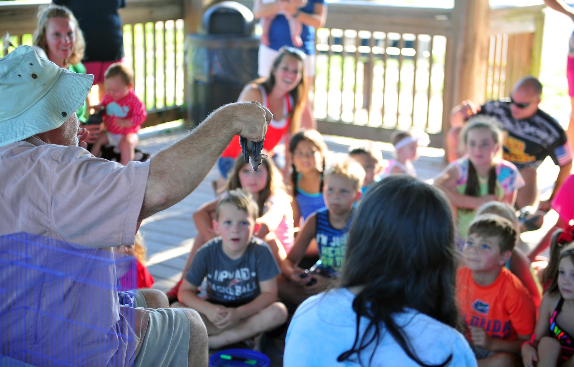 Todd Quinn, a zoology instructor at Lighthouse Christian Academy, holds up a bat for Hurlburt Field children to see during a Key Spouse and Deployed Family Barbeque at the Soundside Marina on Hurlburt Field, Fla., June 23, 2016.Quinn entertained children with various fuzzy creatures in his care while explaining about each of the animals unique characteristics. (U.S. Air Force photo by Staff Sgt. Kentavist P. Brackin)