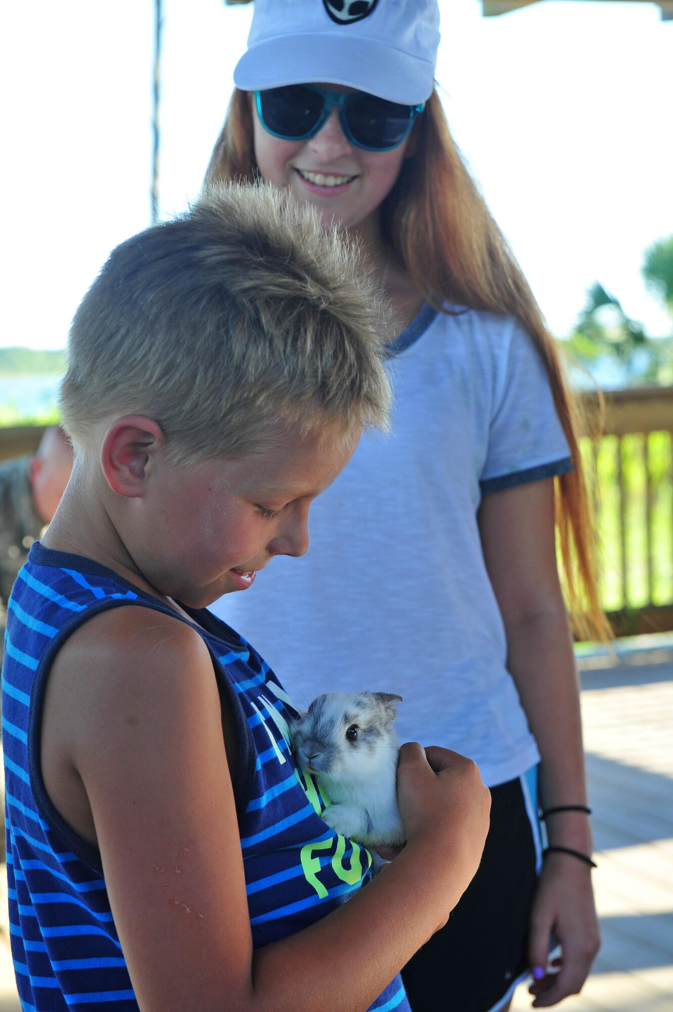 A Hurlburt Field child holds a rabbit during a animal encounter event at the Soundside Marina on Hurlburt Field, Fla., June 23, 2016. The animal introdctions were part of a Key Spouse and Deployed Family Barbeque, one of several events hosted by the Airmen and Family Readiness Center to help familes of deployed Airmen develope and strengthen their support network. (U.S. Air Force photo by Staff Sgt. Kentavist P. Brackin)