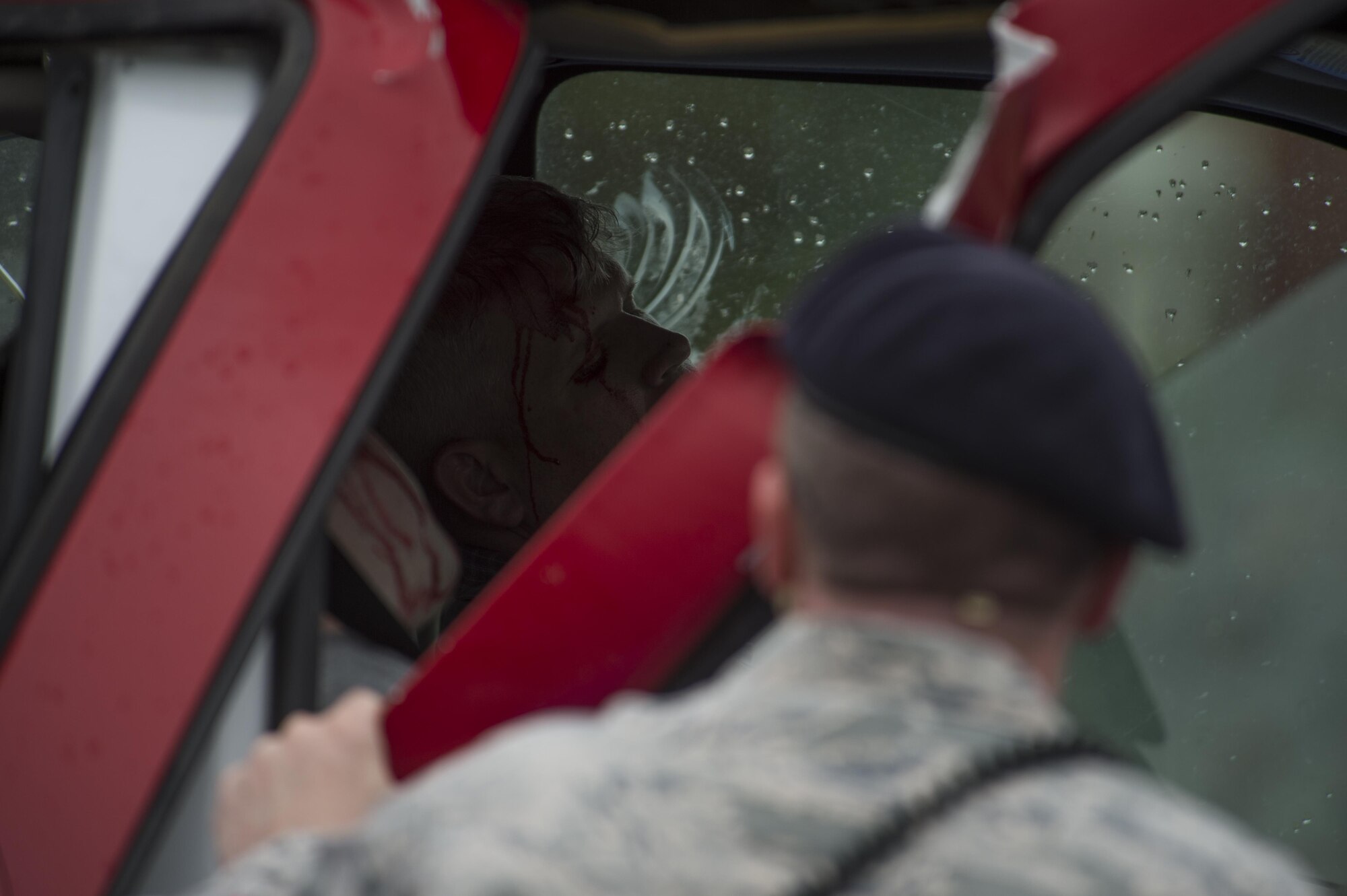 Staff Sgt. James Hebert, a 90th Security Forces Squadron member, arrives at a crashed vehicle to assess the condition of Master Sgt. Josh Wilson, 90th Civil Engineering Squadron assistant fire chief, during a drinking and driving awareness event at F.E. Warren Air Force Base, Wyo., June 30, 2016. In the state of Wyoming, it is illegal to drive with a blood alcohol concentration of .08 or above. More than 200 Airman from the 90th Missile Wing attended the event to witness firsthand the devastating effects of a DUI. (U.S. Air Force photo by Staff Sgt. Christopher Ruano)