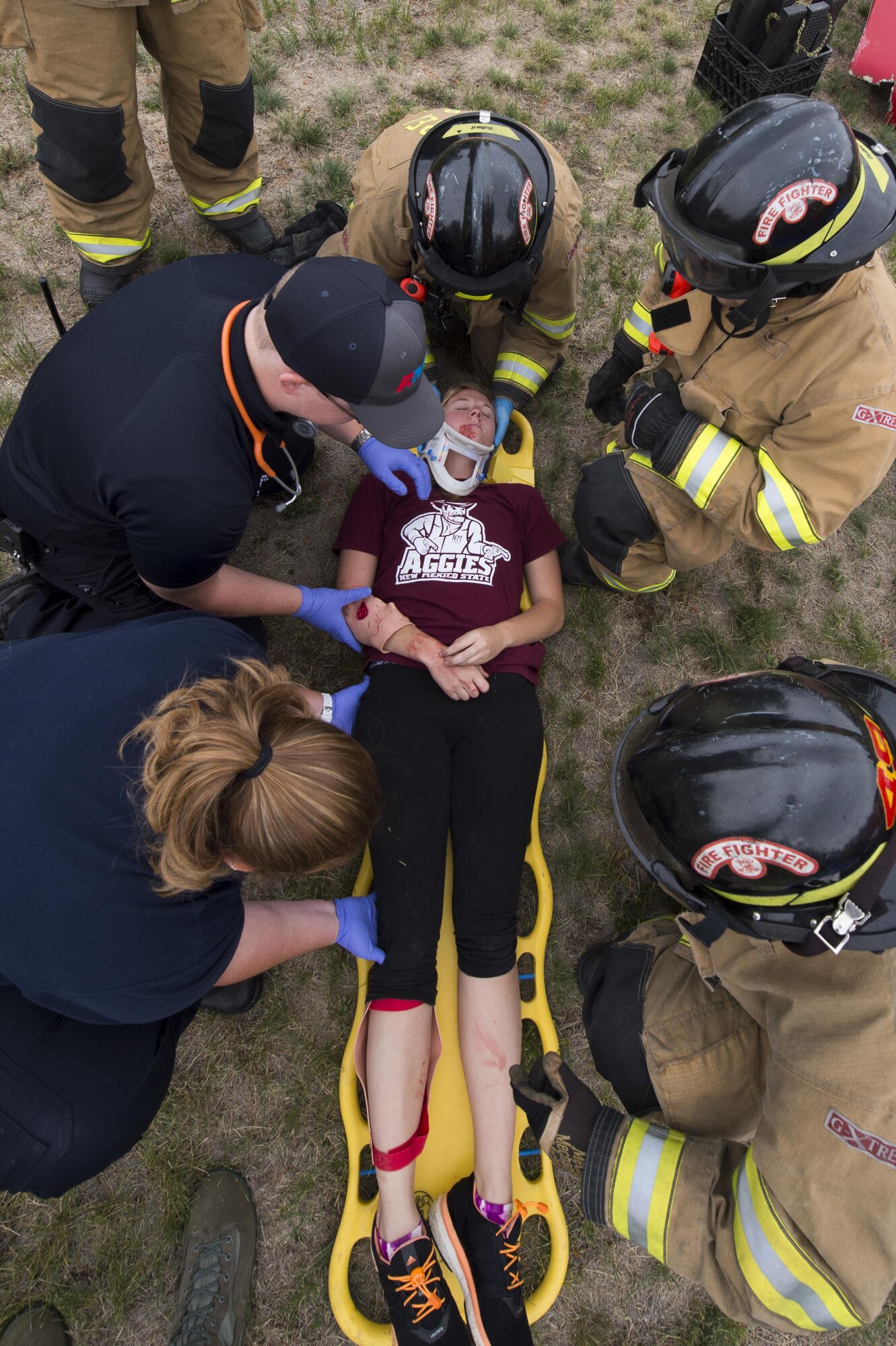 Airman 1st Class Piper Whetstone, a 90th Civil Engineering Squadron firefighter, is assessed for injuries on a gurney during a drinking and driving awareness event at F.E. Warren Air Force Base, Wyo., June 30, 2016. The incident scenario involved multiple emergency response resources from on and off base. More than 200 Airman from the 90th Missile Wing attended the event to witness firsthand the devastating effects of a DUI.  (U.S. Air Force photo by Staff Sgt. Christopher Ruano)