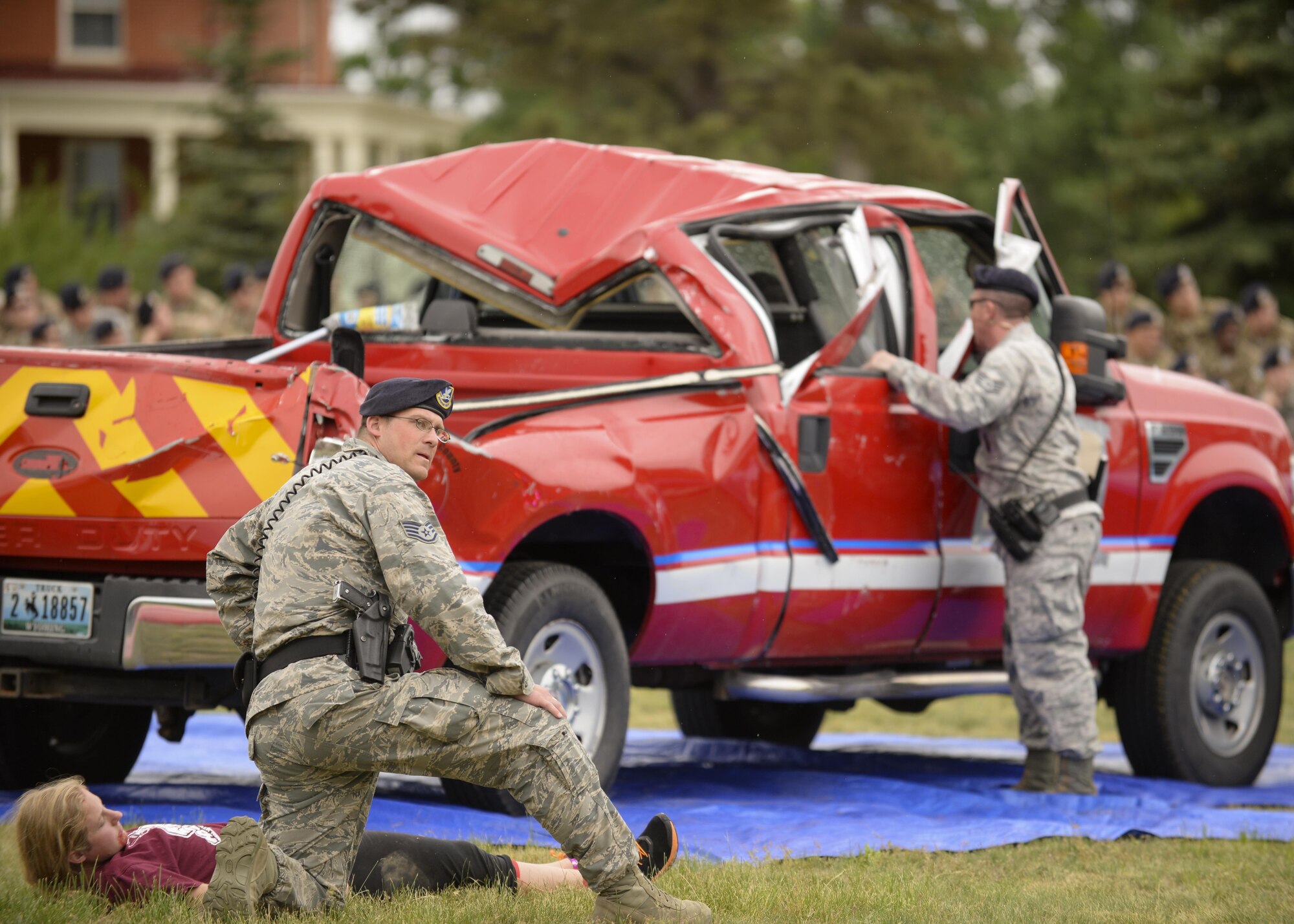 Staff Sergeants Taylor Patrick, left, and James Hebert, right, 90th Security Forces Squadron members, arrive at a crashed vehicle to assess the condition of Airman 1st Class Piper Whetstone, a 90th Civil Engineering Squadron firefighter, during a drinking and driving awareness event at F.E. Warren Air Force Base, Wyo., June 30, 2016. In the state of Wyoming, it is illegal to drive with a blood alcohol concentration of .08 or above. More than 200 Airman from the 90th Missile Wing attended the event to witness firsthand the devastating effects of a DUI. (U.S. Air Force photo by Airman 1st Class Malcolm Mayfield)