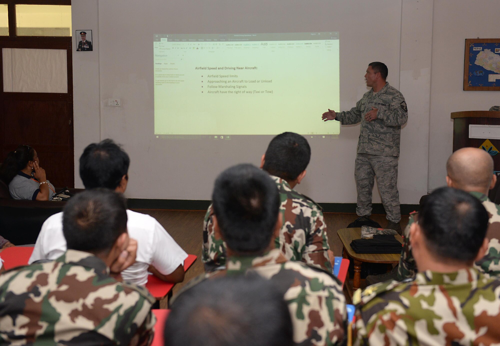 Master Sgt. Clint Hutchinson, 36th Contingency Response Group, briefs U.S. Airmen and Nepalese service members on airfield driving procedures during a subject-matter expert exchange on cargo handling June 28, 2016, at Tribhuvan International Airport in Kathmandu, Nepal. Ten Airmen from the 36th CRG and more than 20 participants from various Nepalese organizations exchanged knowledge on all elements of cargo handling. (U.S. Air Force photo by Staff Sgt. Benjamin Gonsier/Released)