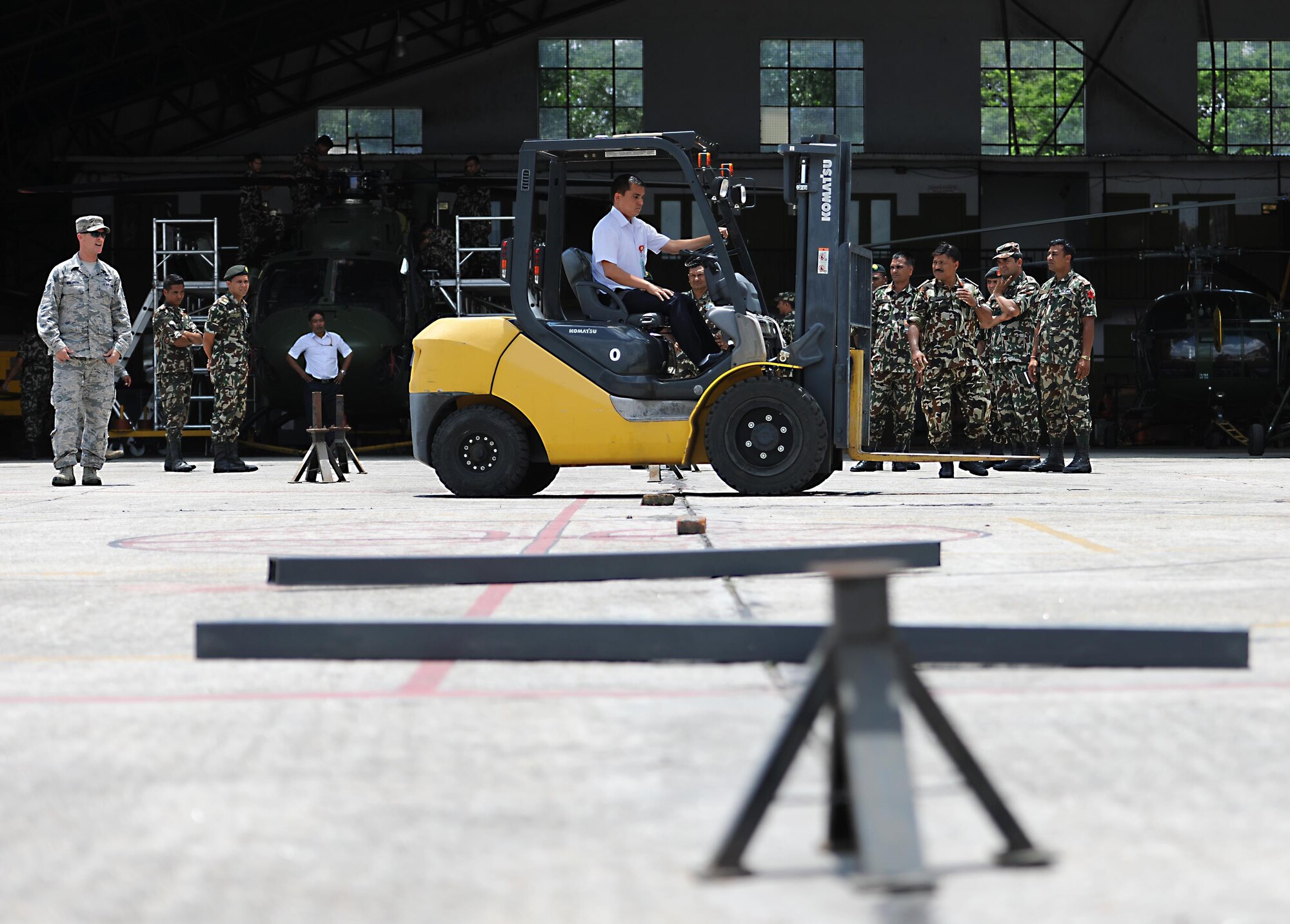 Madhu Sudan, Civil Aviation Authority of Nepal, drives a forklift through an obstacle course during a subject-matter expert exchange on cargo handling June 28, 2016, at Tribhuvan International Airport in Kathmandu, Nepal. T'he obstacle course tested a forklift operators’ ability to navigate around obstacles as safely as possible. (U.S. Air Force photo by Staff Sgt. Benjamin Gonsier/Released)