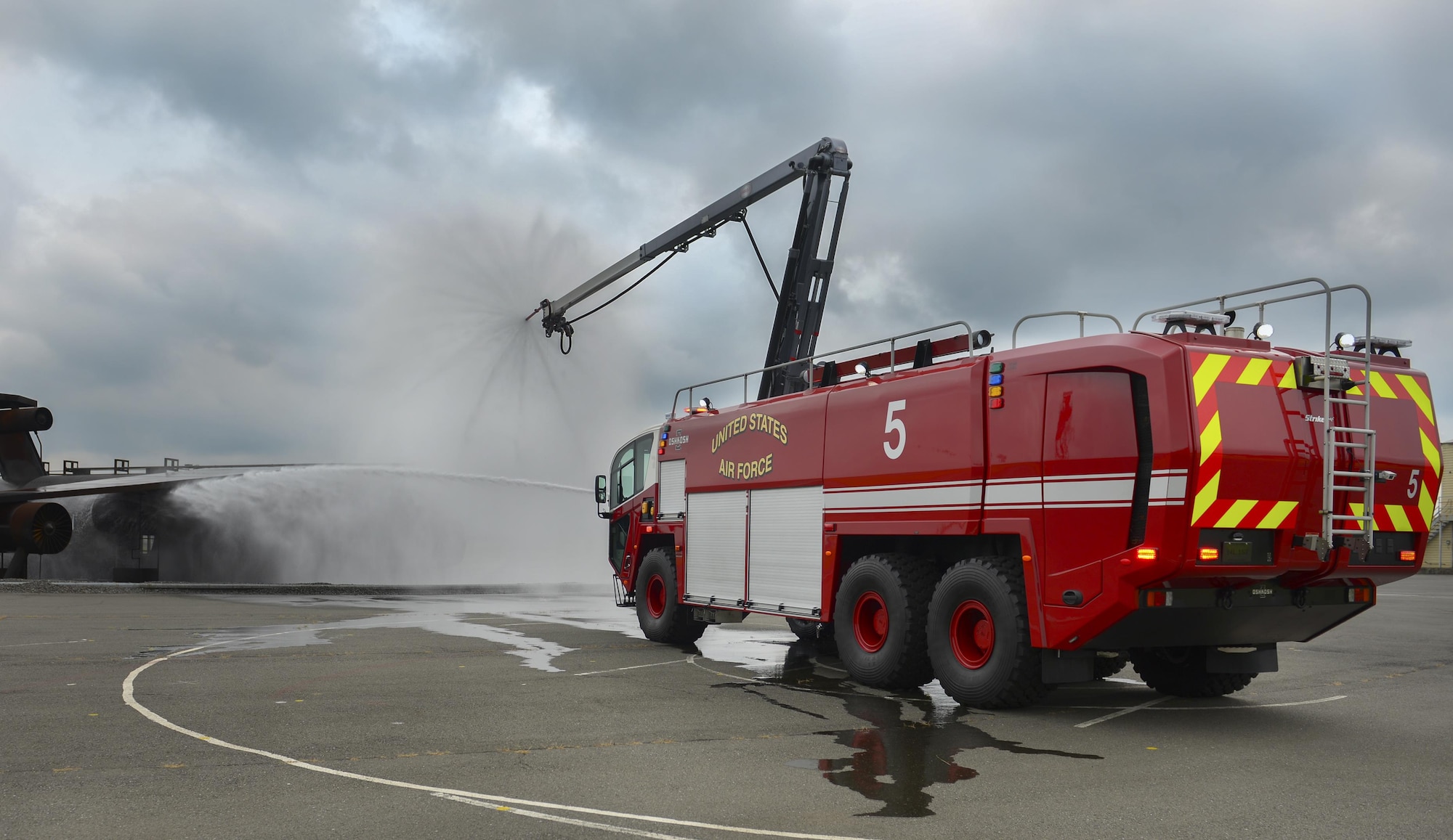 Airman 1st Class Thomas Smith, 373th Civil Engineer Squadron firetruck driver operator, demonstrates the Striker 3,000 fire truck’s capabilities at Yokota Air Base, Japan, June 28, 2016. The Striker 3,000 is Yokota’s newest firetruck, equipped with a boom that extends 75 feet longer than older models, giving it a total range of 750 feet.  (U.S. Air Force photo by Airman 1st Class Baker/Released)