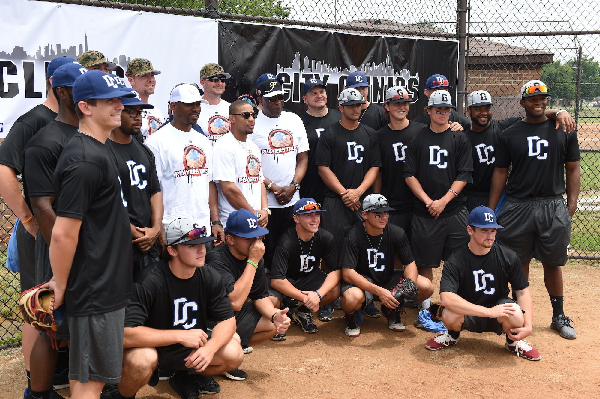 Washington Nationals team members pose for a photo with collegiate baseball players at the Major League Baseball Players Trust City Clinic’s youth baseball clinic on Joint Base Andrews, Md., June 28, 2016. The Players Trust, DC Grays, a Cal Ripken Collegiate Baseball League team, and USO Metro coordinated this event. More than 100 children attended the clinic, receiving coaching from collegiate and professional baseball players, as well as free baseballs, gloves, T-shirts and autograph cards. (U.S. Air Force photo by Senior Airman Joshua R. M. Dewberry)