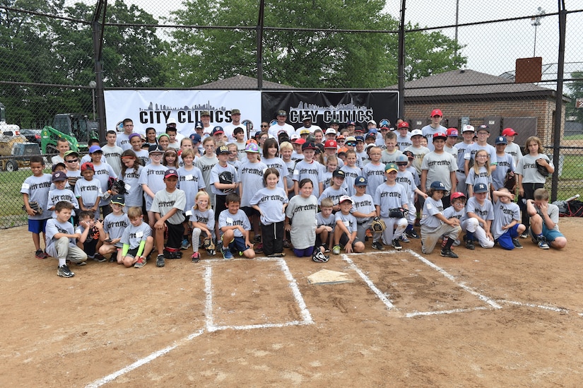 Washington Nationals team members pose for a photo with children of military personnel at the Major League Baseball Players Trust City Clinic’s youth baseball clinic on Joint Base Andrews, Md., June 28, 2016. The Players Trust, DC Grays, a Cal Ripken Collegiate Baseball League team, and USO Metro coordinated this event. More than 100 children attended the clinic, receiving coaching from collegiate and professional baseball players, as well as free baseballs, gloves, T-shirts and autograph cards. (U.S. Air Force photo by Senior Airman Joshua R. M. Dewberry)