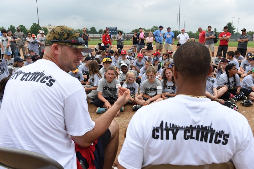 (Left) Clint Robinson, Washington Nationals first baseman, and (right) Ben Revere, Washington Nationals outfielder, answer questions from children of military personnel at the Major League Baseball Players Trust City Clinic’s youth baseball clinic on Joint Base Andrews, Md., June 28, 2016. The Players Trust, DC Grays, a Cal Ripken Collegiate Baseball League team, and USO Metro coordinated this event. More than 100 children attended the clinic, receiving coaching from collegiate and professional baseball players, as well as free baseballs, gloves, T-shirts and autograph cards. (U.S. Air Force photo by Senior Airman Joshua R. M. Dewberry)