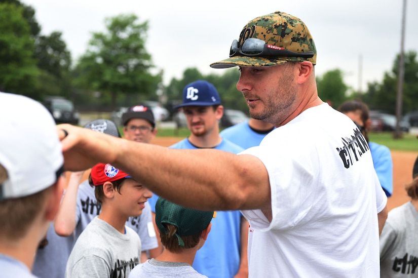 Clint Robinson, Washington Nationals first baseman, picks teams for drills with children of military personnel at the Major League Baseball Players Trust City Clinic’s youth baseball clinic on Joint Base Andrews, Md., June 28, 2016. The Players Trust, DC Grays, a Cal Ripken Collegiate Baseball League team, and USO Metro coordinated this event. More than 100 children attended the clinic, receiving coaching from collegiate and professional baseball players, as well as free baseballs, gloves, T-shirts and autograph cards. (U.S. Air Force photo by Senior Airman Joshua R. M. Dewberry)