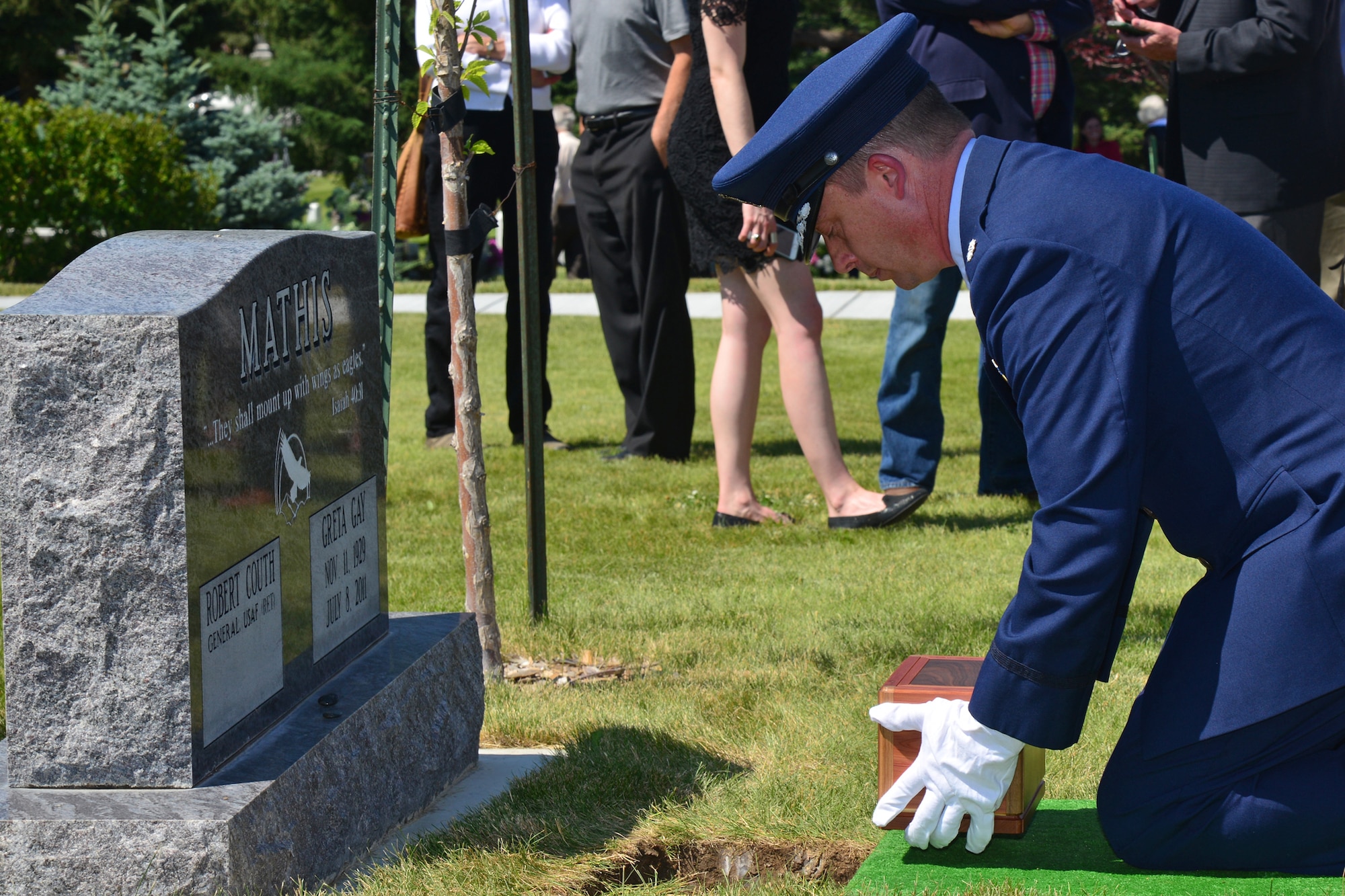 Lt. Col. Michael Epper, 341st Force Support Squadron commander, places retired Gen. Robert Mathis’ remains into the ground during his funeral June 29, 2016, in Bozeman, Mont. Mathis served 34 years in the U.S. Air Force, and was the vice chief of staff of the Air Force 1980-1982. (U.S. Air Force photo/ Airman 1st Class Daniel Brosam)