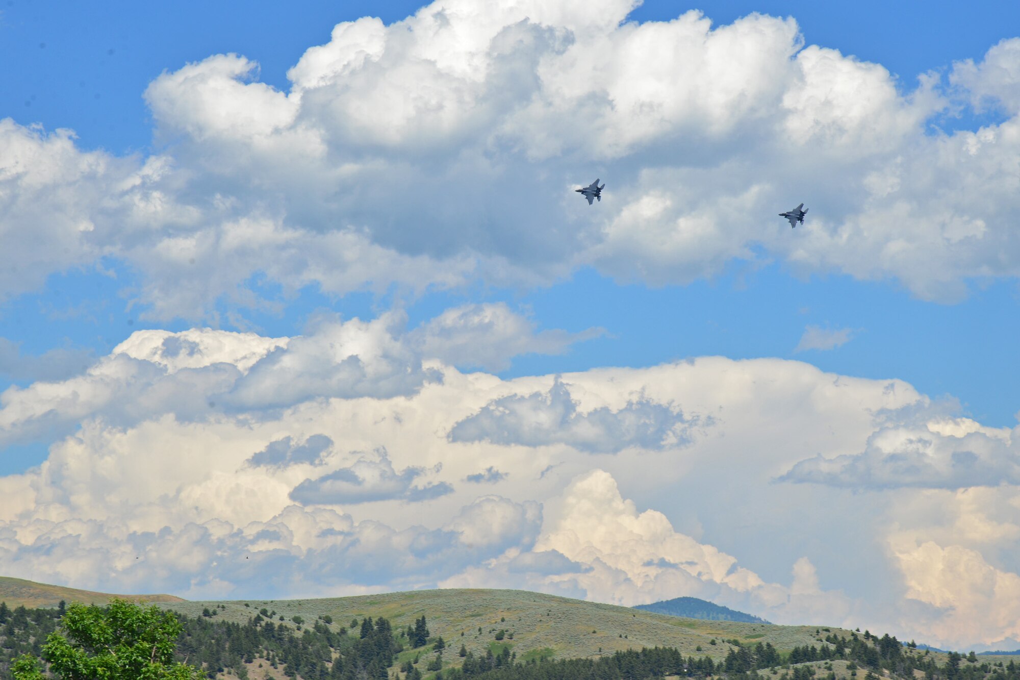 A set of F-15 Eagle aircraft from Mountain Home Air Force Base, Idaho, perform a fly-over during a funeral service for retired Gen. Robert Mathis June 29, 2016, in Bozeman, Mont. Mathis served 34 years in the U.S. Air Force, and was the vice chief of staff of the Air Force 1980-1982. (U.S. Air Force photo/ Airman 1st Class Daniel Brosam)
