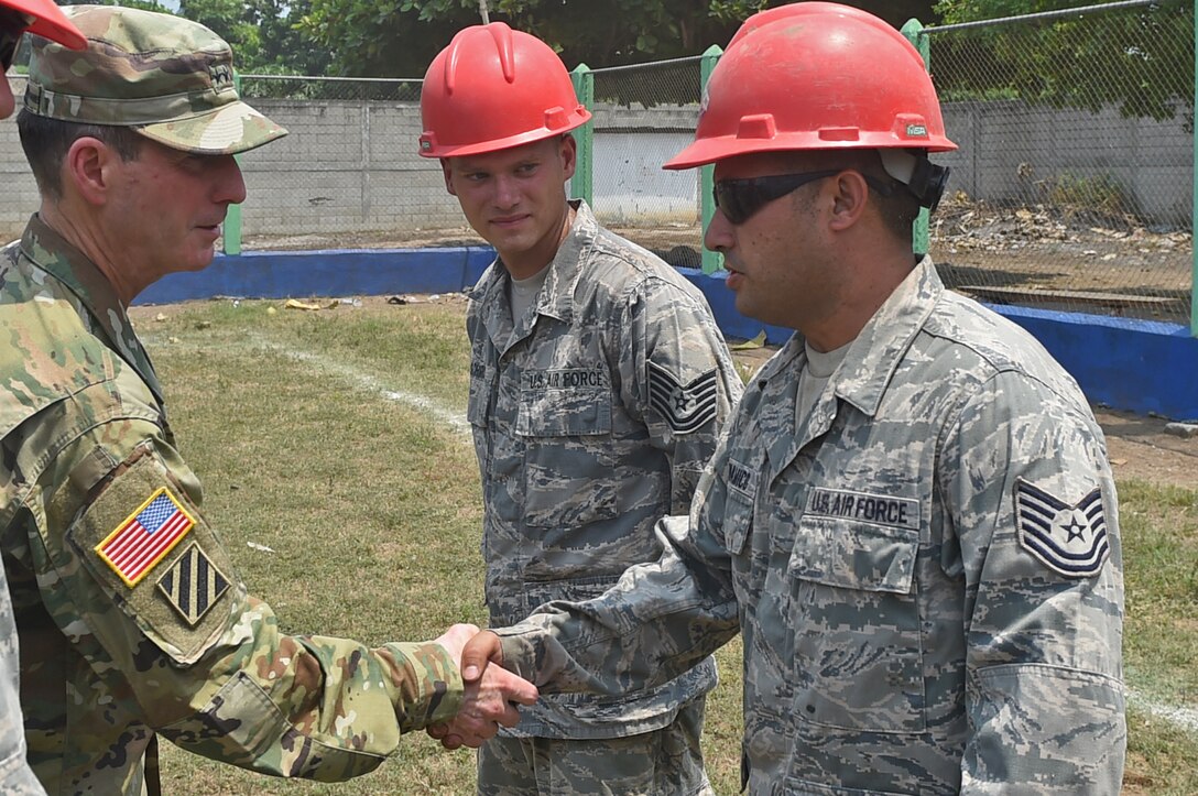 U.S. Army Lt. Gen. Joseph DiSalvo, left, U.S. Southern Command military deputy commander, shakes hands with Pennsylvania Air National Guard Tech. Sgt. Joseph Bonamico, 201st Rapid Engineer Deployable Heavy Operations Repair Squadron Engineer structures technician, outside the construction site of a new medical clinic May 17, 2016, during Exercise BEYOND THE HORIZON 2016 GUATEMALA. Bonamico showed DiSalvo the progress of the construction site to give DiSalvo a better understanding of work conditions. (U.S. Air Force photo by Senior Airman Dillon Davis)