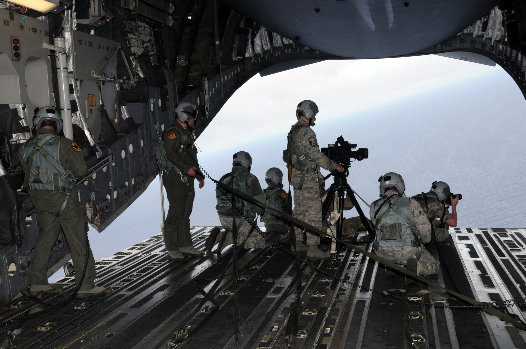 ANG Creative captures video and still imagery during an aerial photo shoot on board a 204th Airlift Squadron C-17 Globemaster, May 18, 2016, Hawaii. ANG Creative is the the Air National Guard visual information team tasked with producing video, radio, photography and graphic design for the ANG Recruiting and Retention Service of the Air Directorate at the National Guard Bureau. (U.S. Air National Guard photo by Airman Stan Pak/released)