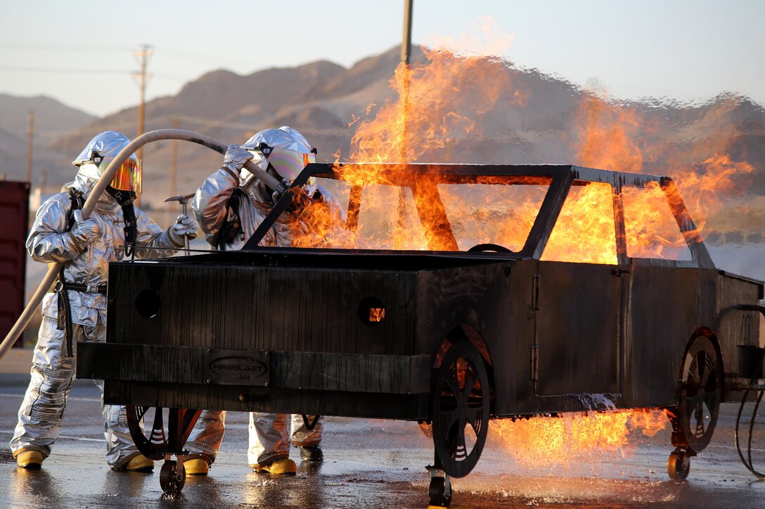 Marines hone their skills in a simulated scenario of a car fire at Marine Ground Air Combat Center Twentynine Palms, Calif., June 23, 2016. The exercise enables the Marines to remain proficient in aircraft rescue and firefighting. Marine Corps photo by Cpl. Booker Thomas