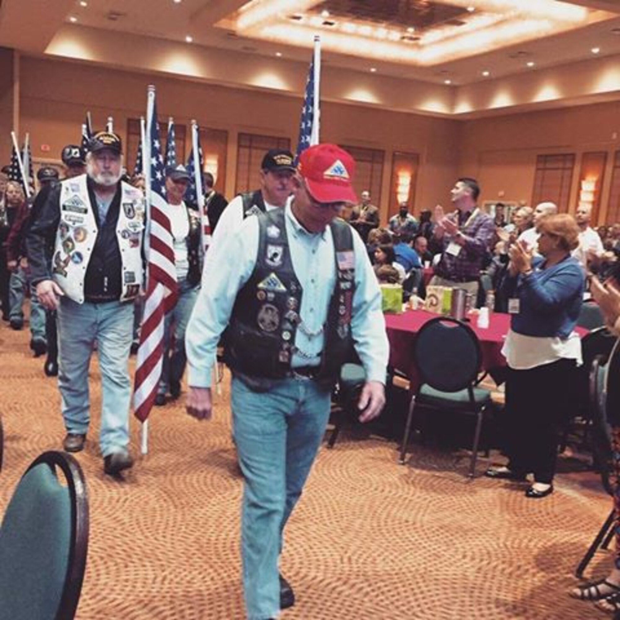 Patriot Guard Riders receive a standing ovation from service members and their families attending the Air Force Reserve Yellow Ribbon event in Orlando Feb. 27-28. The PGR's main mission is to attend the funeral services of fallen American heroes as invited guests of the family They went to the YR event to introduce their mission and show their support to Air Force reservists. The Yellow Ribbon Program is a series of events designed to provide members and families with essential resources prior to departure (pre-deployment), a level of stability and support while deployed (during deployment), and successful re-integration techniques after the deployment cycle ends (post deployment). (U.S. Air Force photo/2nd Lt. Anna-Marie Wyant) 