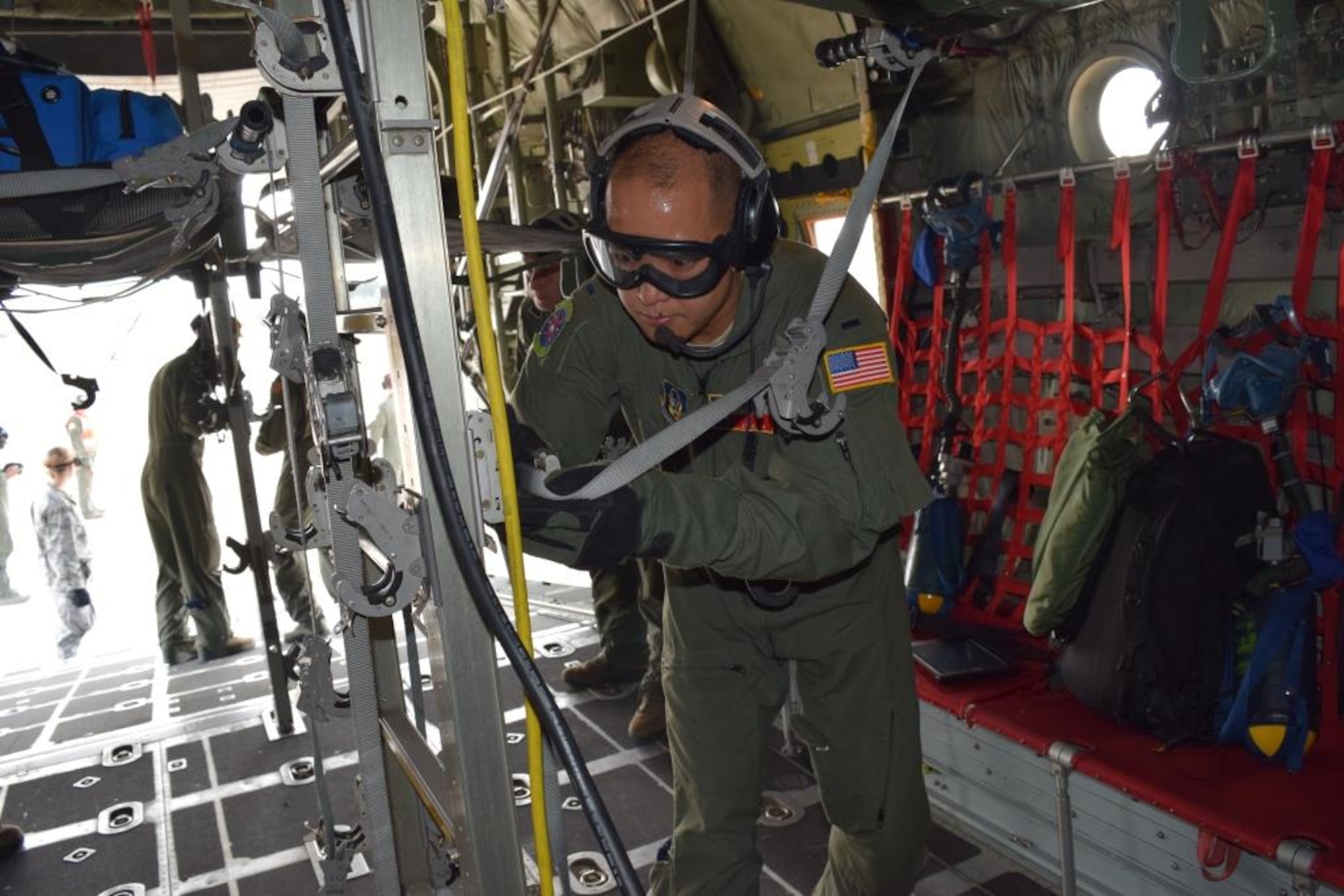 First Lt. J.C. Allen, 433rd Aeromedical Evacuation Squadron flight nurse, secures a stretcher aboard a C-130 Hercules shortly before the injured patients are brought on board during the Alamo Shield exercise at Camp Bullis Training Annex Feb. 27, 2016. Flight nurses and medical technicians are responsible for maintaining the care of patients while being transported in flight. Alamo Shield was an eight-day training exercise designed to deploy and exercise an aeromedical evacuation system in an initial urgent response scenario. (U.S. Air Force photo/Senior Airman Bryan Swink)