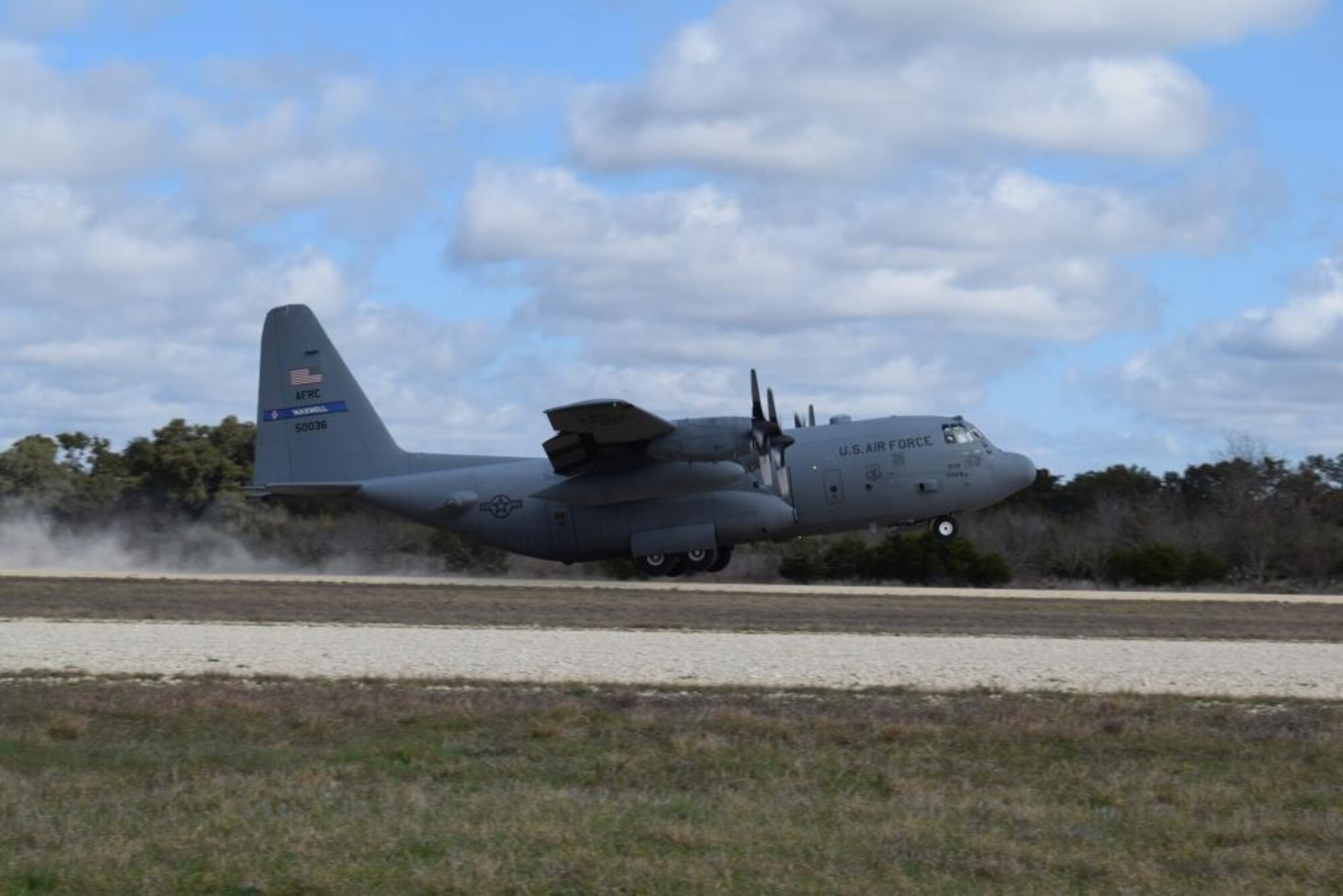 A C-130 Hercules assigned to the 908th Airlift Wing at Maxwell Air Force Base, Alabama takes off from Camp Bullis Training Annex’s assault runway after picking up patients during the aeromedical evacuation exercise, Alamo Shield, Feb. 27, 2016. Members of the 433rd Aeromedical Evacuation Squadron, 433rd Airlift Control Flight, 433rd Aeromedical Staging Squadron and the 433rd Aerospace Medicine Squadron’s Critical Care Air Transport Team worked together to provide the logistics and execution of evacuating injured patients out of the fictitious war zone. (U.S. Air Force photo/Senior Airman Bryan Swink)