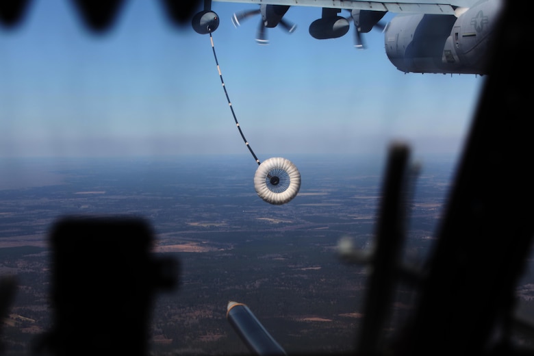A CH-53E Super Stallion approaches a KC-130J Super Hercules refueling hose during  aerial refueling at Exercise Eager Response at Marine Corps Air Station Beaufort, S.C., Feb. 25, 2016. During the exercise, Marines trained in events such as casualty evacuation, assault support missions and aerial refueling, proving the Marine Air-Ground Task Force is a highly effective combat force. (U.S. Marine Corps photo by Pfc. Nicholas P. Baird/Released)