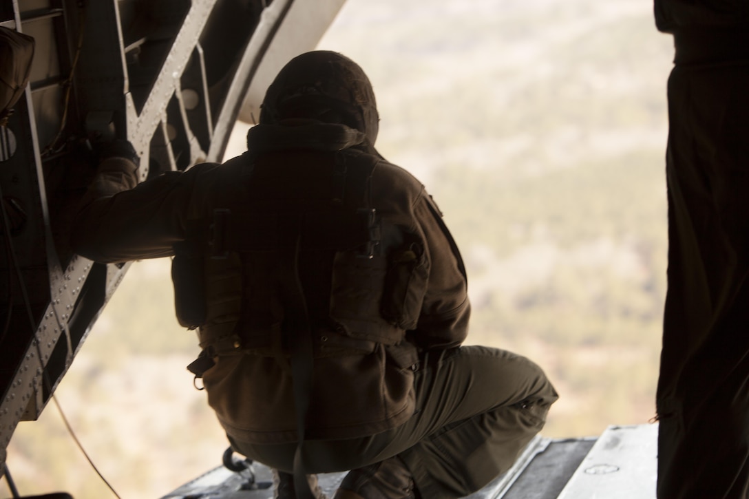 Sgt. Christophe R. Robichaux inspects a CH-53E Super Stallion while in flight during Exercise Eager Response at Marine Corps Air Station Beaufort, S.C., Feb. 25, 2016.  During the exercise, Marines trained in events such as casualty evacuation, assault support missions and aerial refueling, proving the Marine Air-Ground Task Force is a highly effective combat force. Robichaux is a CH-53E crew chief with Marine Heavy Helicopter Squadron 366.  (U.S. Marine Corps photo by Pfc. Nicholas P. Baird/Released)