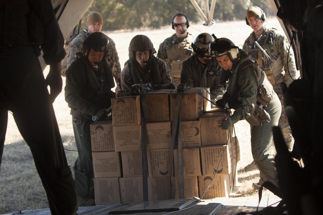 Marines with Marine Heavy Helicopter Squadron 366 load a CH-53E Super Stallion with meals, ready-to-eat during Exercise Eager Response at Marine Corps Air Station Beaufort, S.C., Feb. 25, 2016. During the exercise, Marines trained in events such as casualty evacuation, assault support missions and aerial refueling, proving the Marine Air-Ground Task Force is a highly effective combat force. (U.S. Marine Corps photo by Pfc. Nicholas P. Baird/Released)