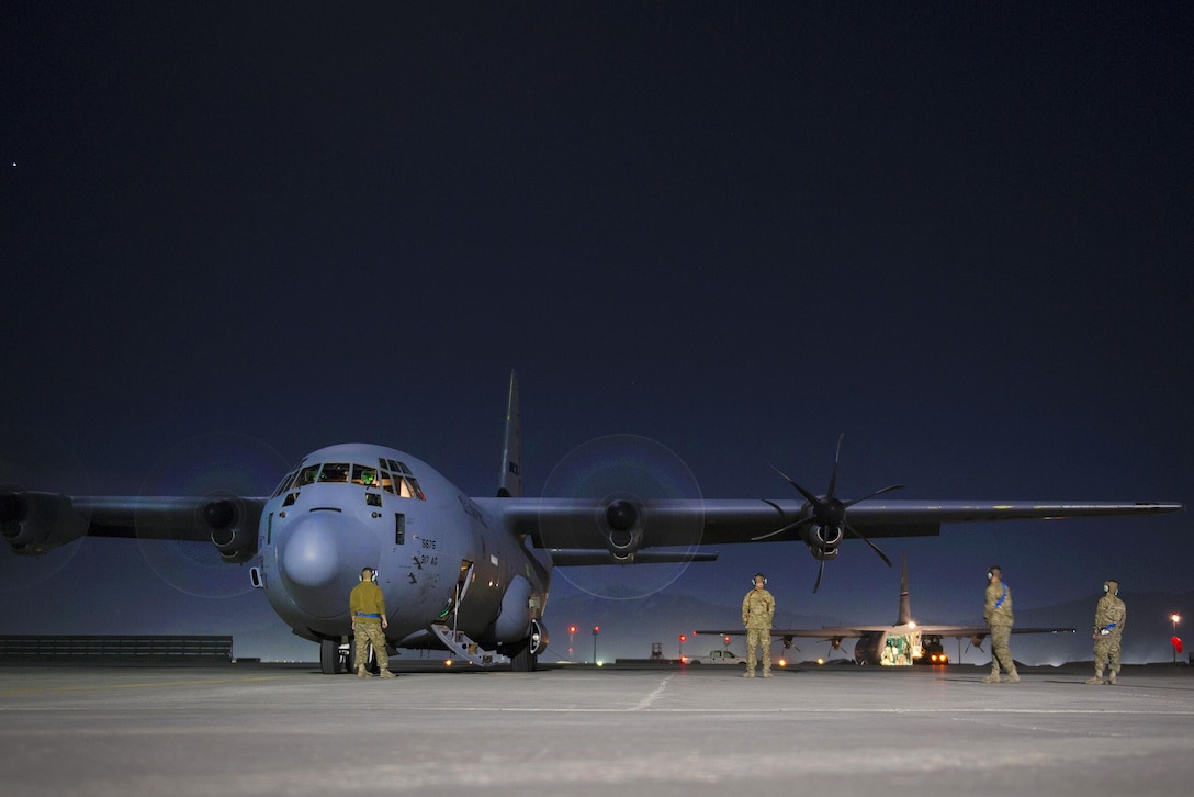 Airmen relay information via headset during an engine run-up and preflight checks on a C-130J Super Hercules aircraft before a sortie on Bagram Airfield, Afghanistan, Feb. 22, 2016. Air Force photo by Tech. Sgt. Robert Cloys