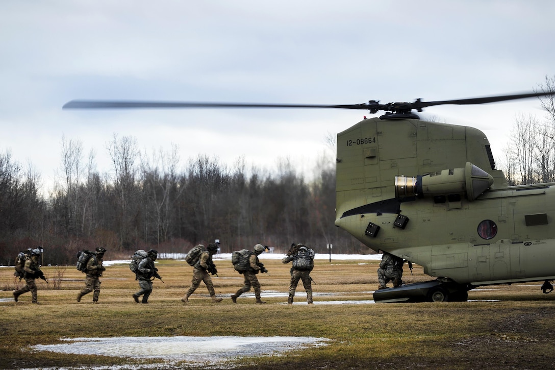 Soldiers prepare to board a CH-47F Chinook helicopter for extraction during a training mission at the Youngstown Local Training area in Youngstown, N.Y., Feb. 20, 2016. The soldiers are assigned to the New York Army National Guard’s C Troop, 2nd Squadron 101st Cavalry and the helicopter crew is assigned to the New York Army National Guard's Company B, 3rd Battalion, 126th Aviation Regiment. The training is in preparation for larger scale exercises to be held throughout the year. New York Air National Guard photo by Staff Sgt. Ryan Campbell