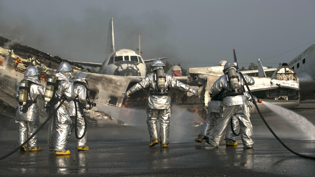 U.S. Marine and Royal Thai sailors move in to a burnt aircraft with hand line hoses to put out spot fires and the rest of the cargo area after they used roof turrets to put out the majority of the flames during Exercise Cobra Gold 16 at Utapao, Thailand, Feb. 19, 2016. This training event was designed to build relationships between the two firefighting groups. Cobra Gold is a multi-national exercise with focuses on preserving and promoting peace in the Asia-Pacific region. The Marines with the aircraft rescue and firefighting section with Marine Wing Support Squadron 172, Marine Aircraft Group 36, 1st Marine Aircraft Wing, III Marine Expeditionary Force.
