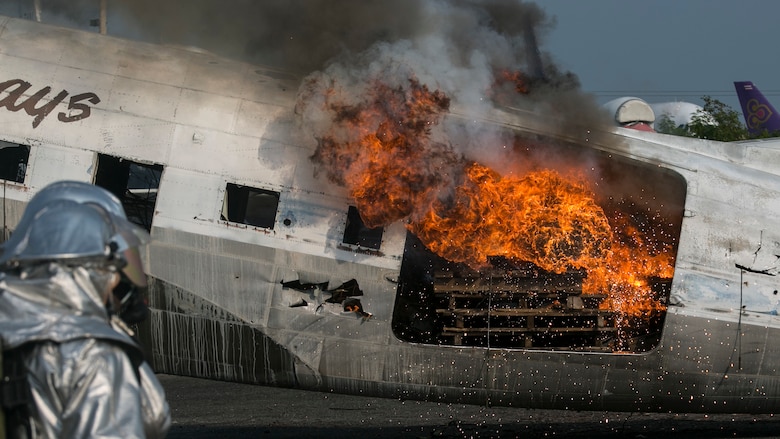 Vicious flames engulf an unserviceable aircraft as U.S. Marines and Royal Thai sailors prepare to put it out during Cobra Gold 16 at Utapao, Thailand, Feb. 19, 2016. The Marines and sailors started the process by using roof turrets to put out the majority of the fire. Then they moved in with hand lines to tackle spot fires in the cargo area. Cobra Gold is a multi-national exercise designed to preserve and promote peace and security in the Asia-Pacific region.