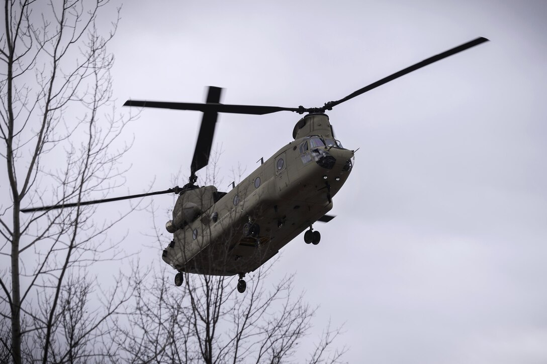 A CH-47F Chinook helicopter approaches a landing zone to insert soldiers and extract another group at the Youngstown Local Training Area in Youngstown, N.Y., Feb. 20, 2016. New York Air National Guard photo by Staff Sgt. Ryan Campbell