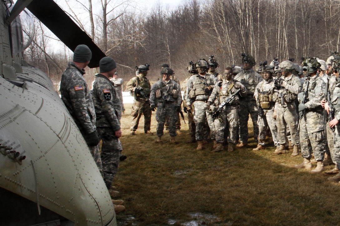 Army Staff Sgt. Jeff Lentz, left, and Army Sgt. Mike Landauer give a mission and safety brief to soldiers about the CH-47 Chinook helicopter before participating in an aerial insertion and extraction training mission at the Youngstown Local Training Area in Youngstown, N.Y., Feb. 20, 2016. Lentz and Landauer are assigned to the New York Army National Guard’s Company B, 3rd Battalion, 126th Aviation Regiment. New York Air National Guard photo by Sgt. Jonathan Monfiletto