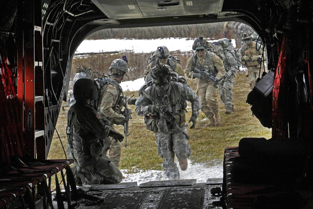 Soldiers board a CH-47F Chinook helicopter during an insertion and extraction training mission at the Youngstown Local Training Area in Youngstown, N.Y., Feb. 20, 2016. New York Air National Guard photo by Sgt. Jonathan Monfiletto