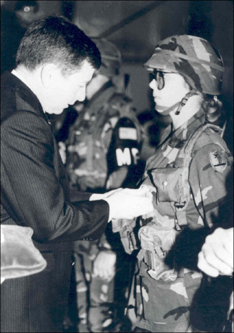 Pvt. 1st Class Charla Shull receives her Missouri National Guard Panama Service Ribbon from Gov. John Ashcroft when she and the other members of the 1138th Military Police Company returned home from Operation JUST CAUSE. 