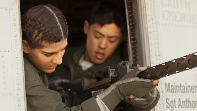 Lance Cpl. Samantha Alaw, left, and Cpl. Eun C. Lee mount a .50-caliber machine gun onto a CH-53E Super Stallion during Exercise Eager Response at Marine Corps Air Station Beaufort, S.C., Feb. 25, 2016. During the exercise, Marines trained in events such as casualty evacuation, assault support missions and aerial refueling, proving the 2nd Marine Aircraft Wing is a highly effective combat force. Alaw is a CH-53E crew chief with Marine Heavy Helicopter Squadron 366, and Lee is a CH-53E airframe mechanic with HMM-366.