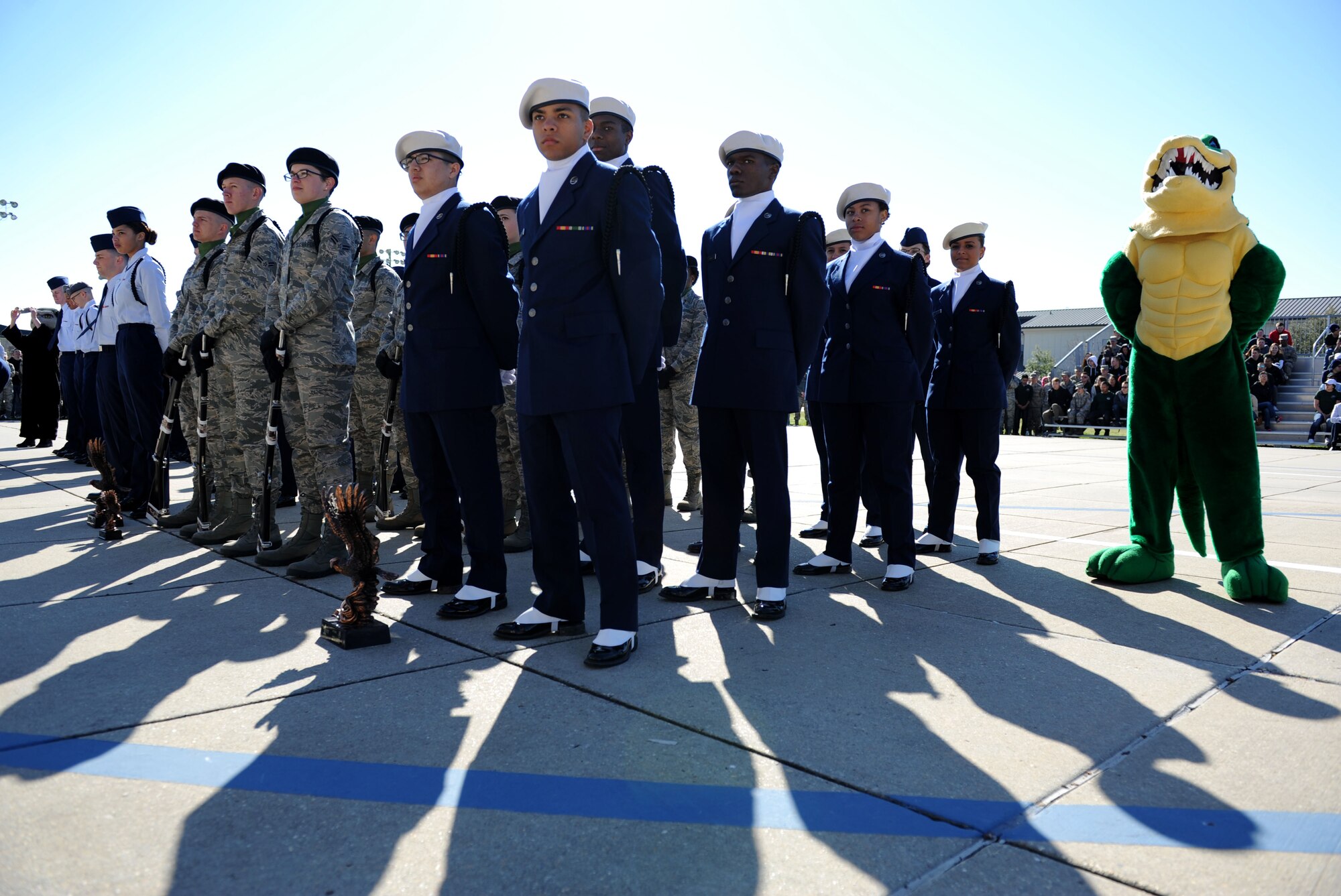 Members of the 334th Training Squadron drill teams stand in formations as the competition results are announced during the 81st Training Group drill down at the Levitow Training Support Facility drill pad Feb. 26, 2016, Keesler Air Force Base, Miss. The 334th TRS “Gators” placed first overall. (U.S. Air Force photo by Kemberly Groue)