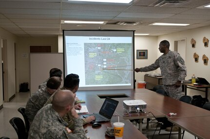 U.S. Army Reserve Soldiers with the 961st Engineer Battalion, provide a command update brief to Lt. Col. Maynard Spell, commander, 961st Engineer Battalion, during the 961st Engineer Battalion's third Defense Support of Civil Authorities tabletop exercise in Seagoville, Texas, Feb. 25 to 28. (U.S. Army photo by Staff Sgt. Debralee Best)