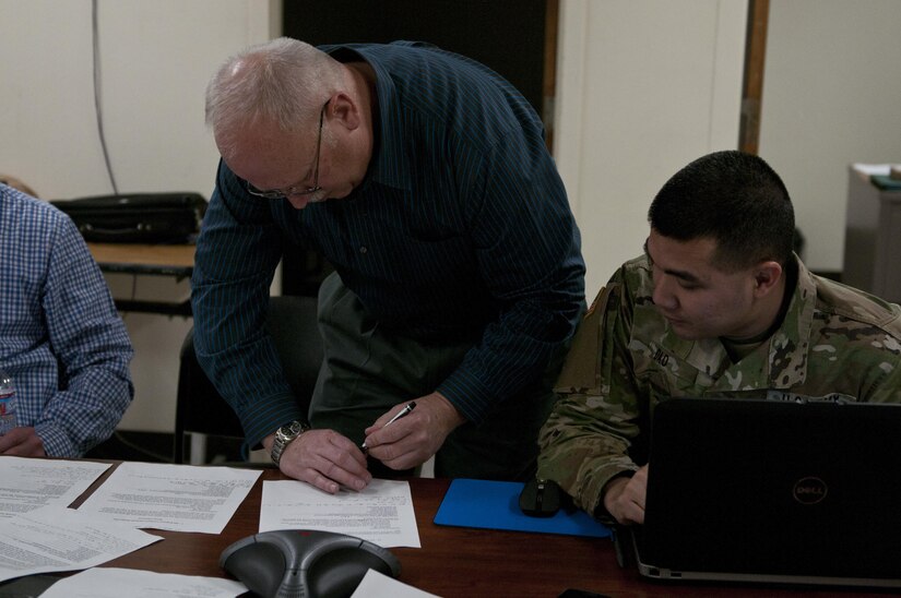 Terry New (left), Regions 6 and 7 Civil Military Project Officer, a Vicksburg, Miss., resident, and Capt. Vinh Dao, current operations logistic officer, United States Army Reserve Command, an Indianapolis resident, roleplay civil authorities during the 961st Engineer Battalion's third Defense Support of Civil Authorities tabletop exercise in Seagoville, Texas, Feb. 25 to 28. (U.S. Army photo by Staff Sgt. Debralee Best)