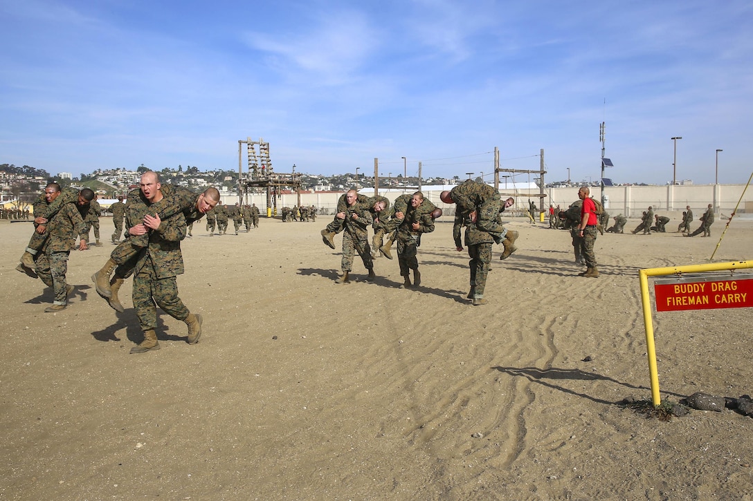 Marine Corps recruits conduct fireman's carry and buddy drag exercises on the confidence course at Marine Corps Recruit Depot San Diego, Feb. 23, 2016. The recruits are assigned to Alpha Company, 1st Recruit Training Battalion. Marine Corps photo by Lance Cpl. Angelica I. Annastas 
