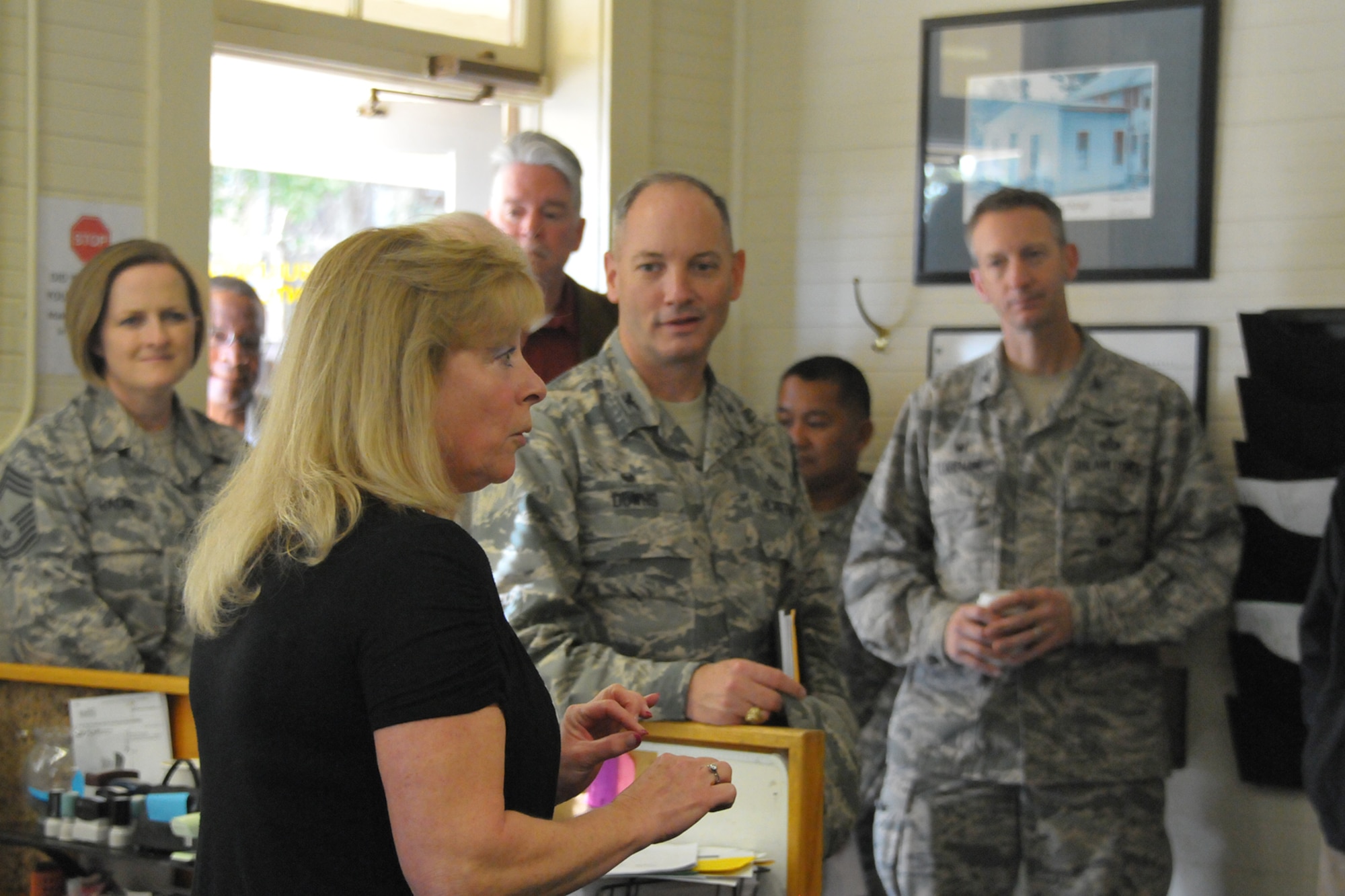 P.J. Kinzie-Garcia, a City of Monterey maintenance technician, guides a tour of the city's maintenance customer service center on the Presidio of Monterey, an Army installation in Monterey California. Military and civic leaders from San Angelo, Texas and Goodfellow Air Force visited the Presidio of Monterey to explore the Monterey, California Army installation's unique civic partnerships. The Monterey Model saves the Army money by sharing resources with the nearby cities of Seaside and Monterey, California, where possible for common municipal and city services, such as public works and safety. A 2000 Army Audit Agency review validated the cost savings, confirming Presidio of Monterey saved 41% over the cost of reimbursements to the Navy (which also operates a small military installation in the area) under a previous agreement, a total savings of more than $2.5 million annually. (courtesy photo)