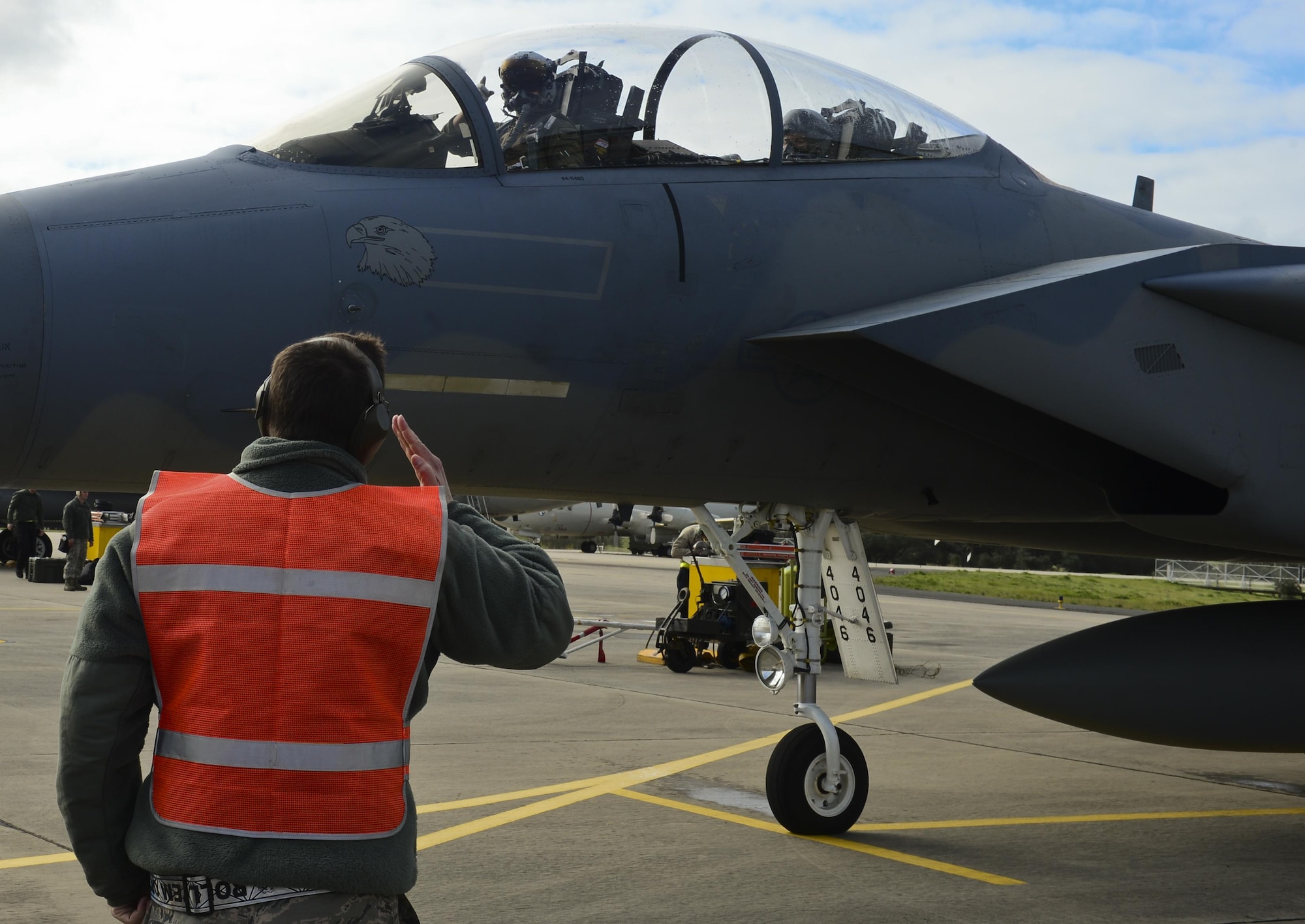 A final salute is rendered, signaling that the aircraft is cleared for takeoff, during exercise Real Thaw at Beja Air Base, Portugal, Feb. 25, 2016. Real Thaw was designed to provide joint interoperability training throughout the execution of a vast range of battlefield missions, facing day and night operations in a high intensity joint setting. (U.S. Air Force photo/Senior Airman Dawn M. Weber)