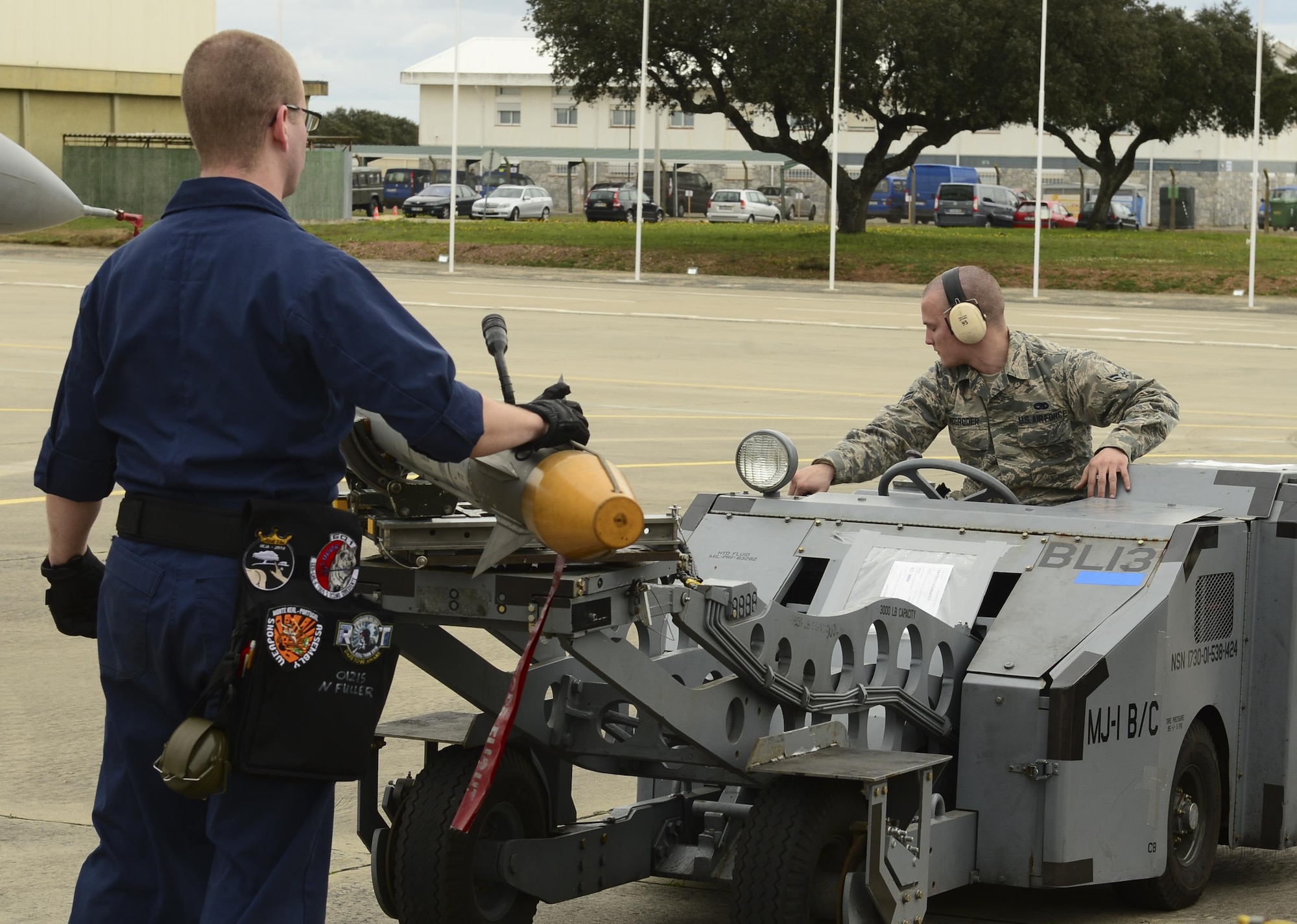 Senior Airman Noah Fuller and Airman 1st Class Edward McGroder, 493rd Aircraft Maintenance Unit weapons load crew members, transport simulated munitions on an MJ-1 Lift Truck during exercise Real Thaw at Beja Air Base, Portugal, Feb. 25, 2016. Real Thaw was designed to provide joint interoperability training throughout the execution of a vast range of battlefield missions, to include day and night operations in a high-intensity joint setting. (U.S. Air Force photo/Senior Airman Dawn M. Weber)