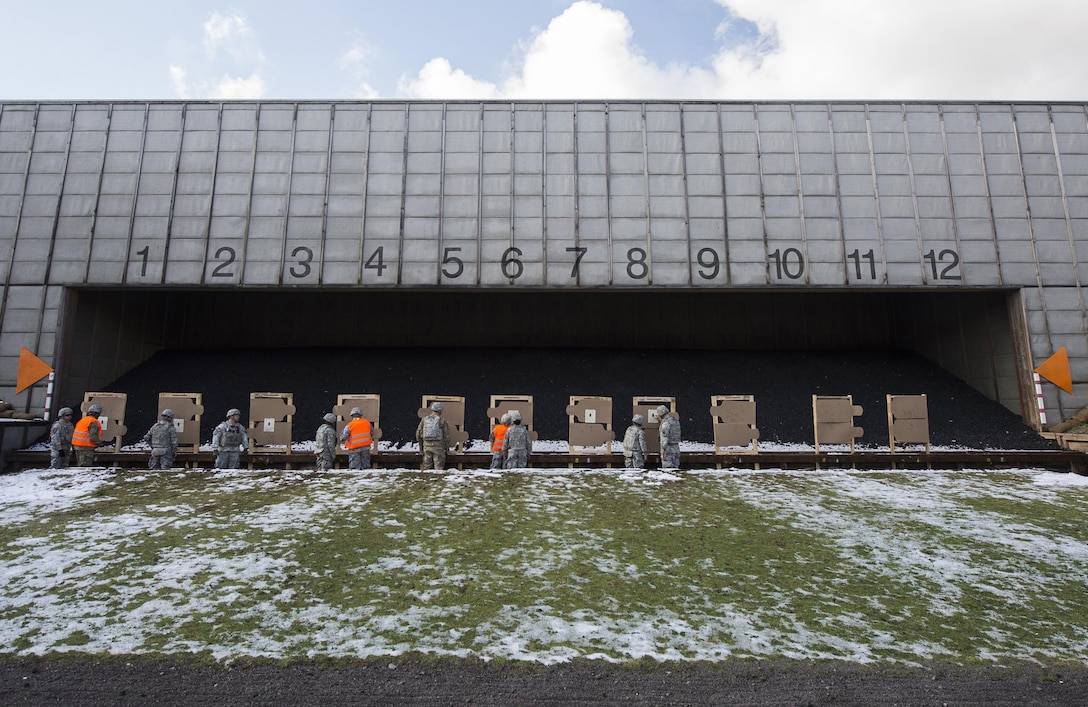 Soldiers check their targets after firing during a weapons qualification test at a military shooting range in Landstuhl, Germany, Feb. 25, 2016. Every soldier at the range wore advanced combat helmets and other personal protective equipment to protect themselves from possible injuries, such as traumatic brain injuries. DoD photo by Air Force Tech. Sgt. Brian Kimball 